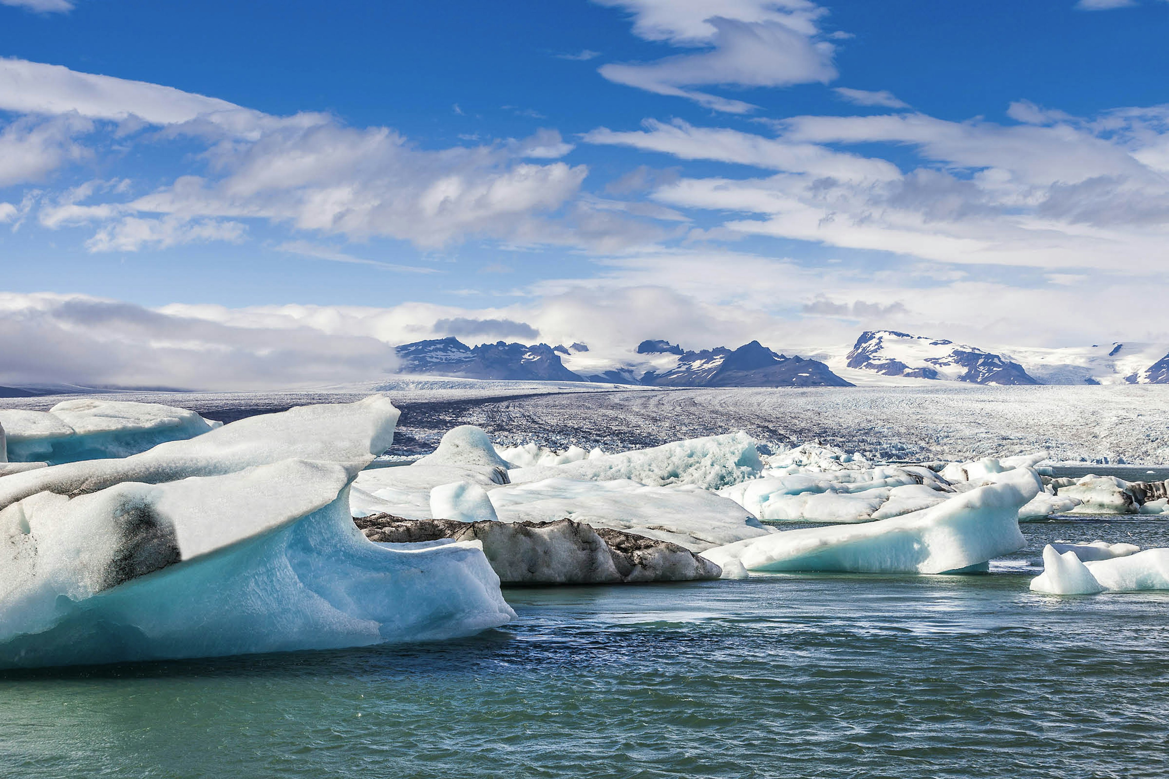 Mini icebergs float in a lake at the foot of the Vatnajökull glacier