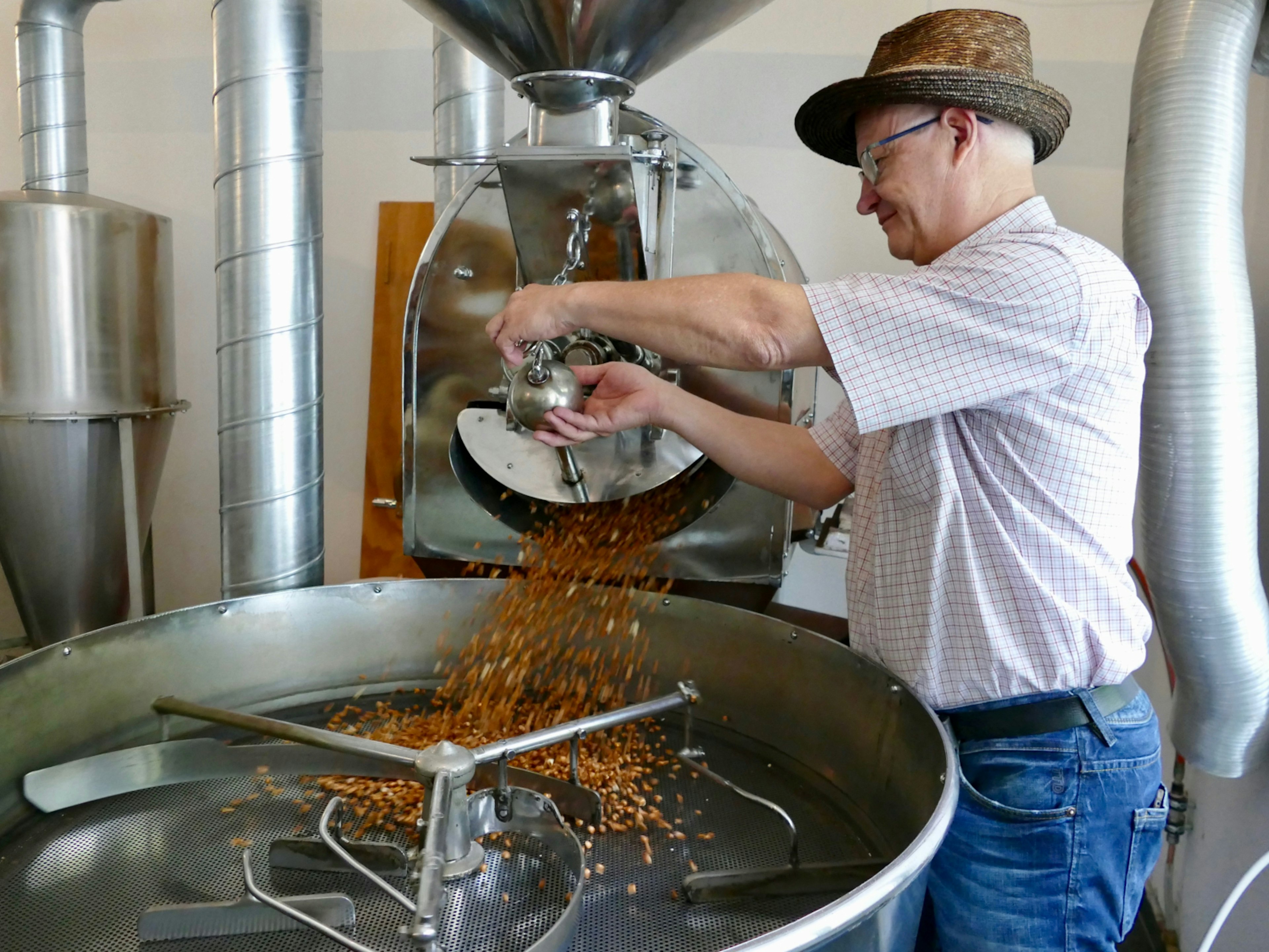 Miller Ilario Garbani roasting corn to make Farina Bóna (good flour) in Ticino, Switzerland © Sarah Gilbert / Lonely Planet