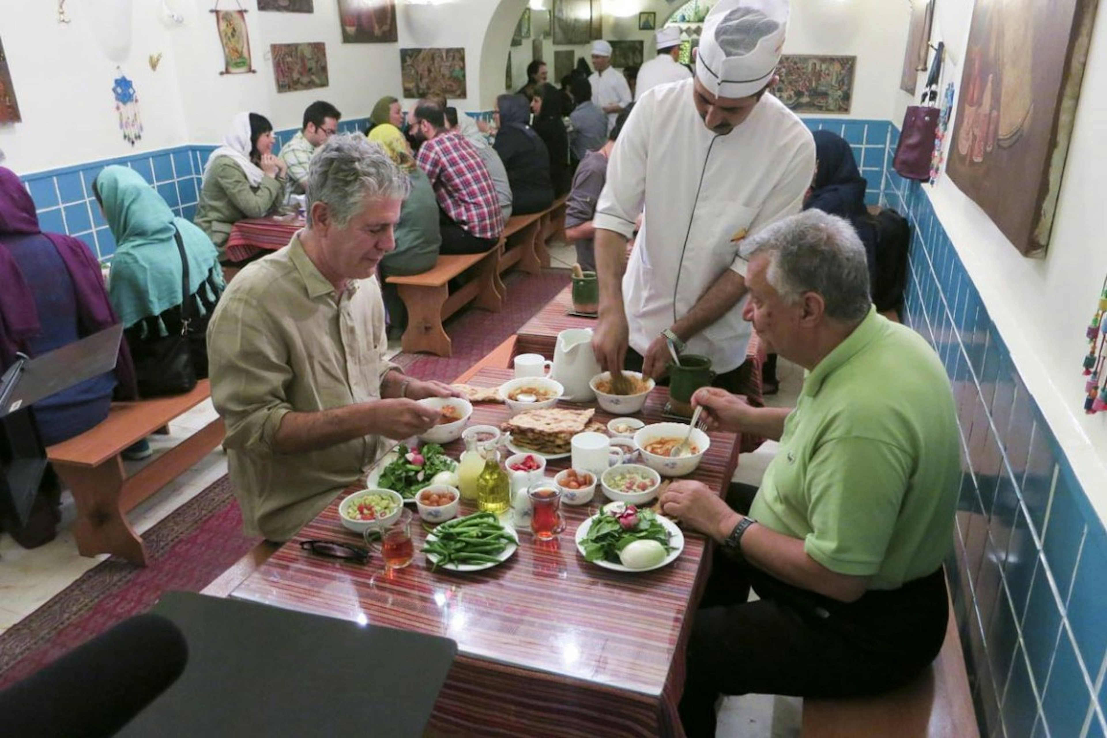 Anthony Bourdain dining with a companion in Iran.