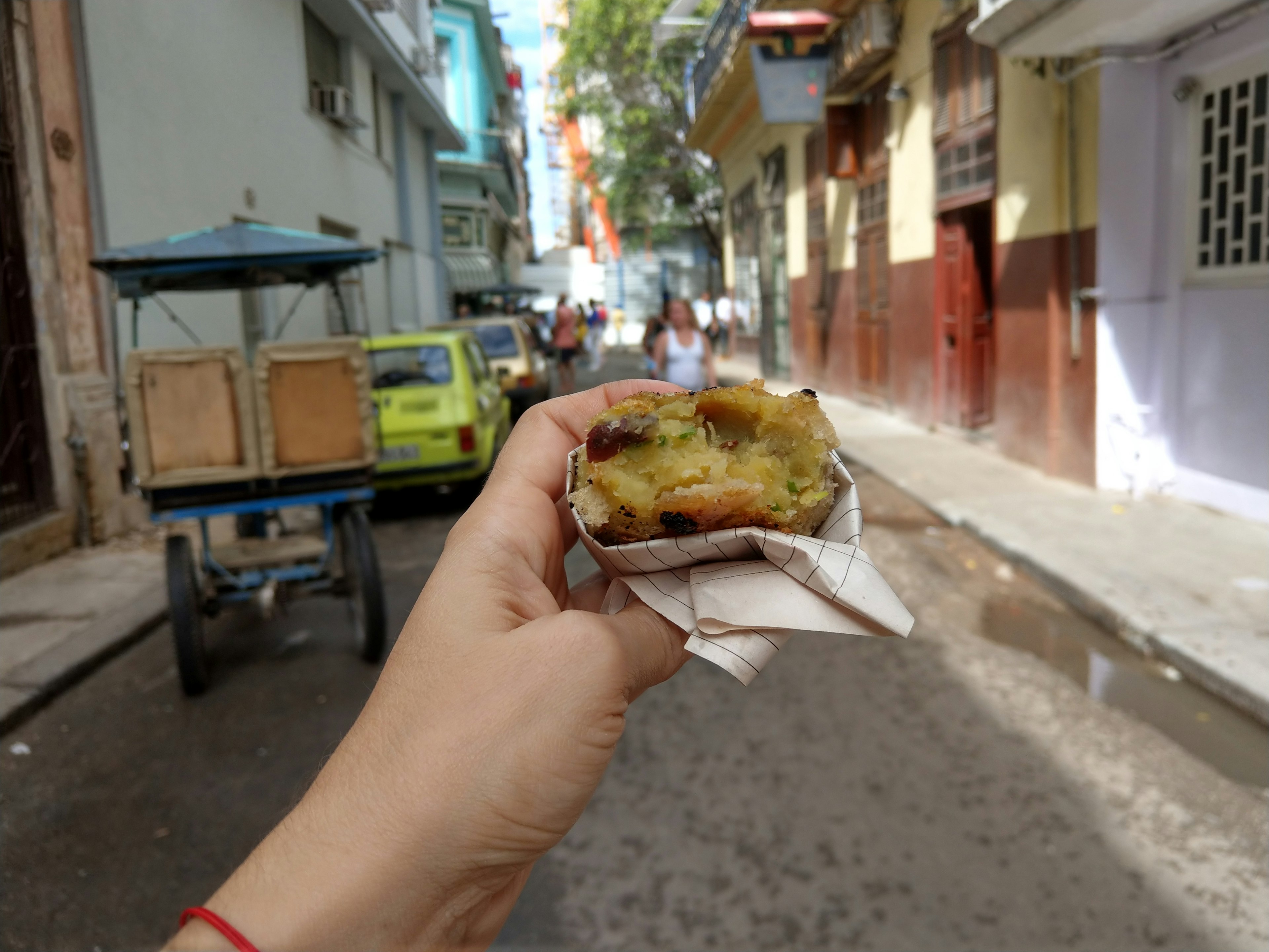 A Japanese sweet potato croquette in front of a Havana street.