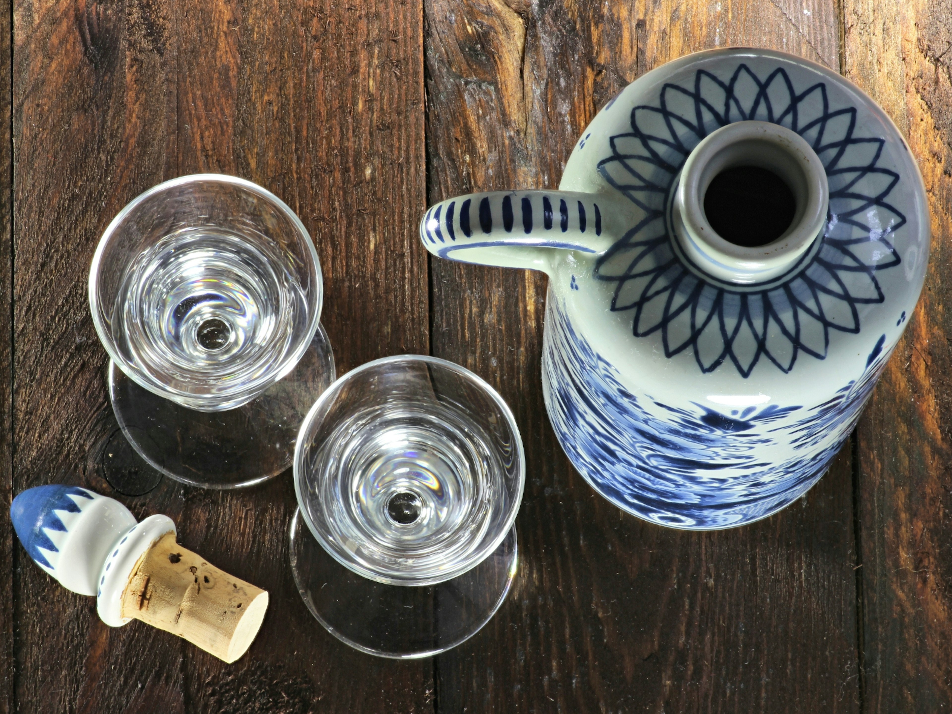 An aerial shot of two glasses of jenever and a decanter