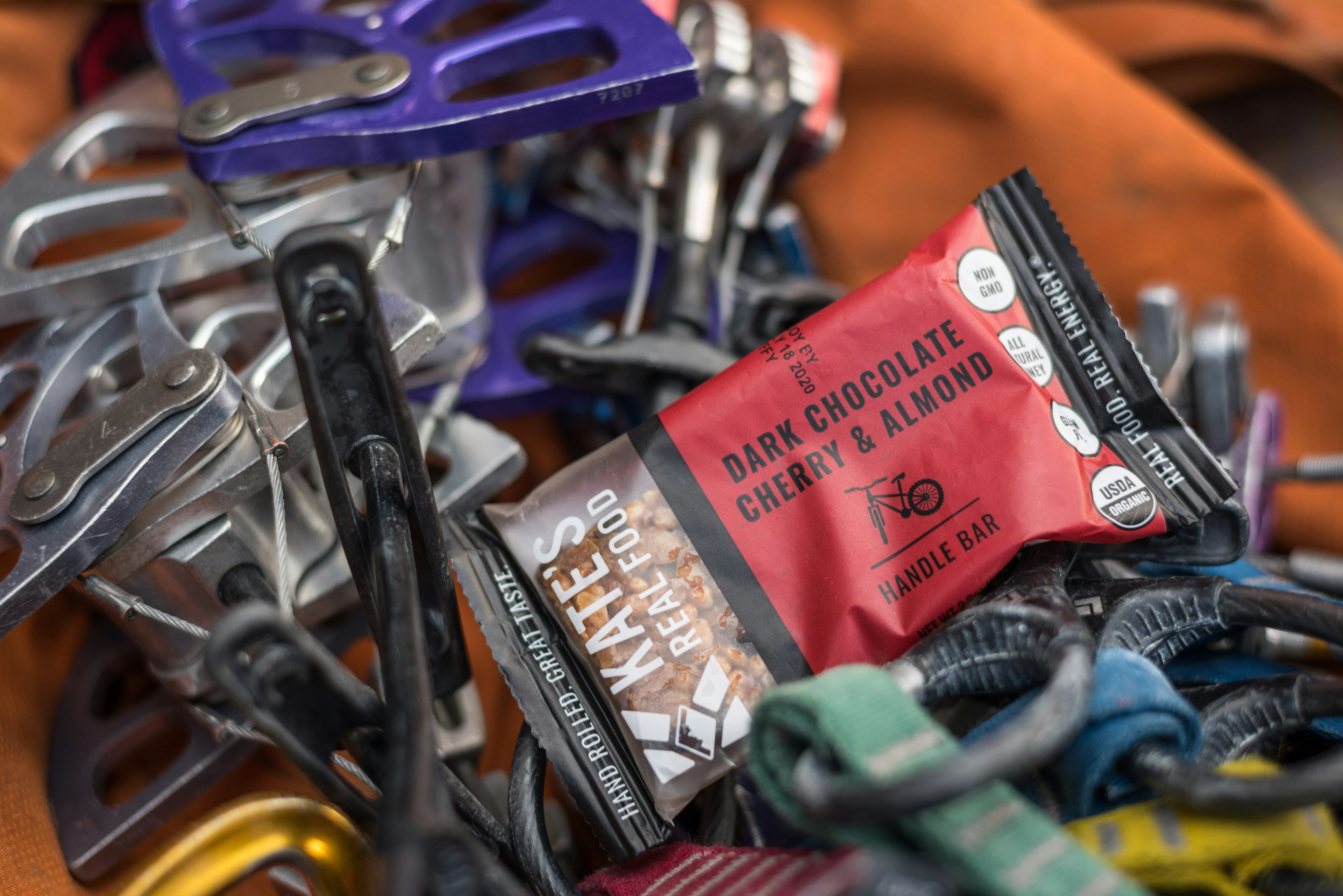 An energy bar from Kate's Real Food on top of a pile of gear