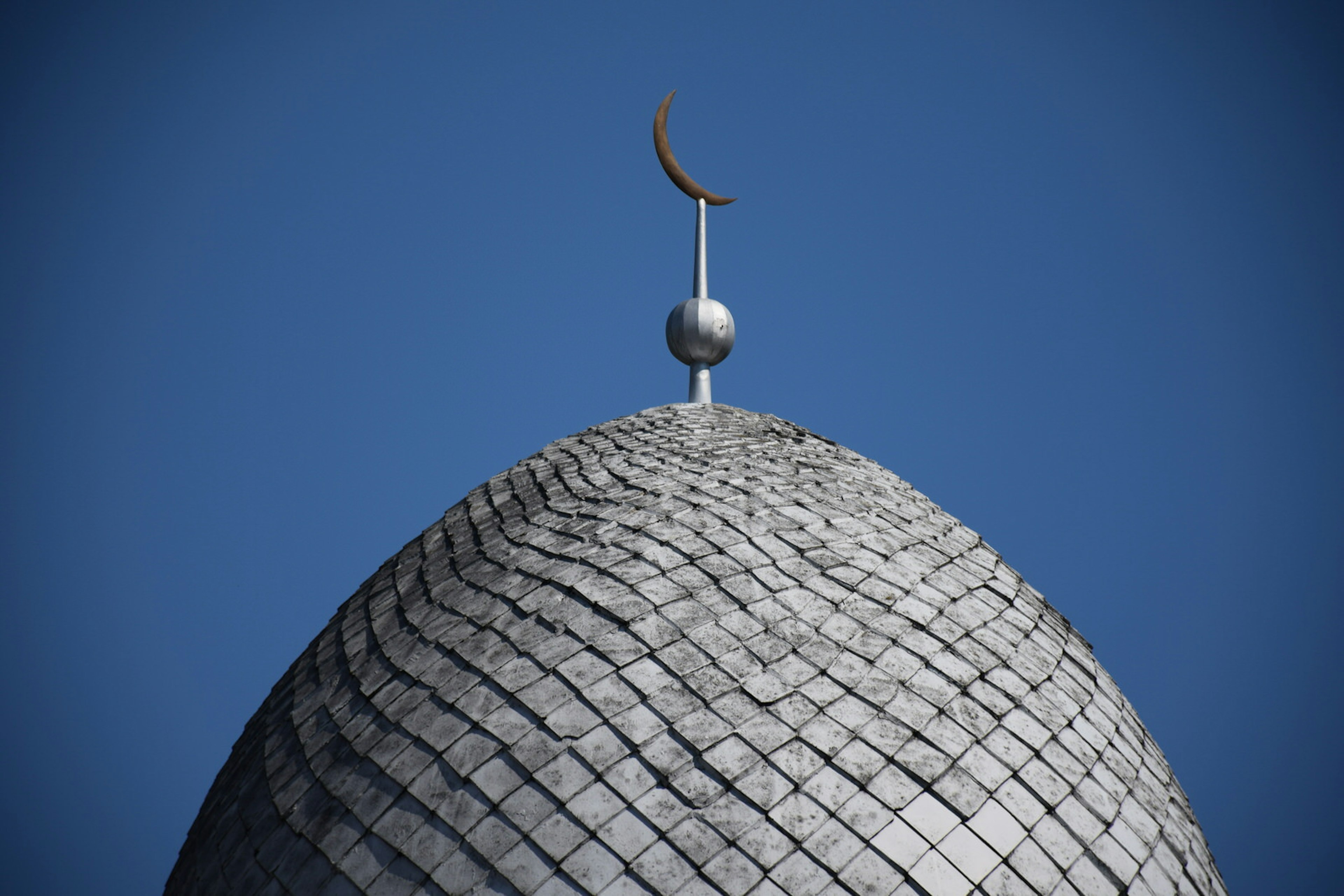 Detail of the tiling on Kaunas Mosque's dome, topped with a crescent