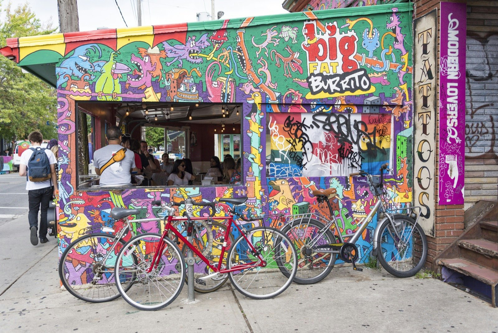 Bicycles parked beside a popular burrito outlet in Kensington Market, Toronto