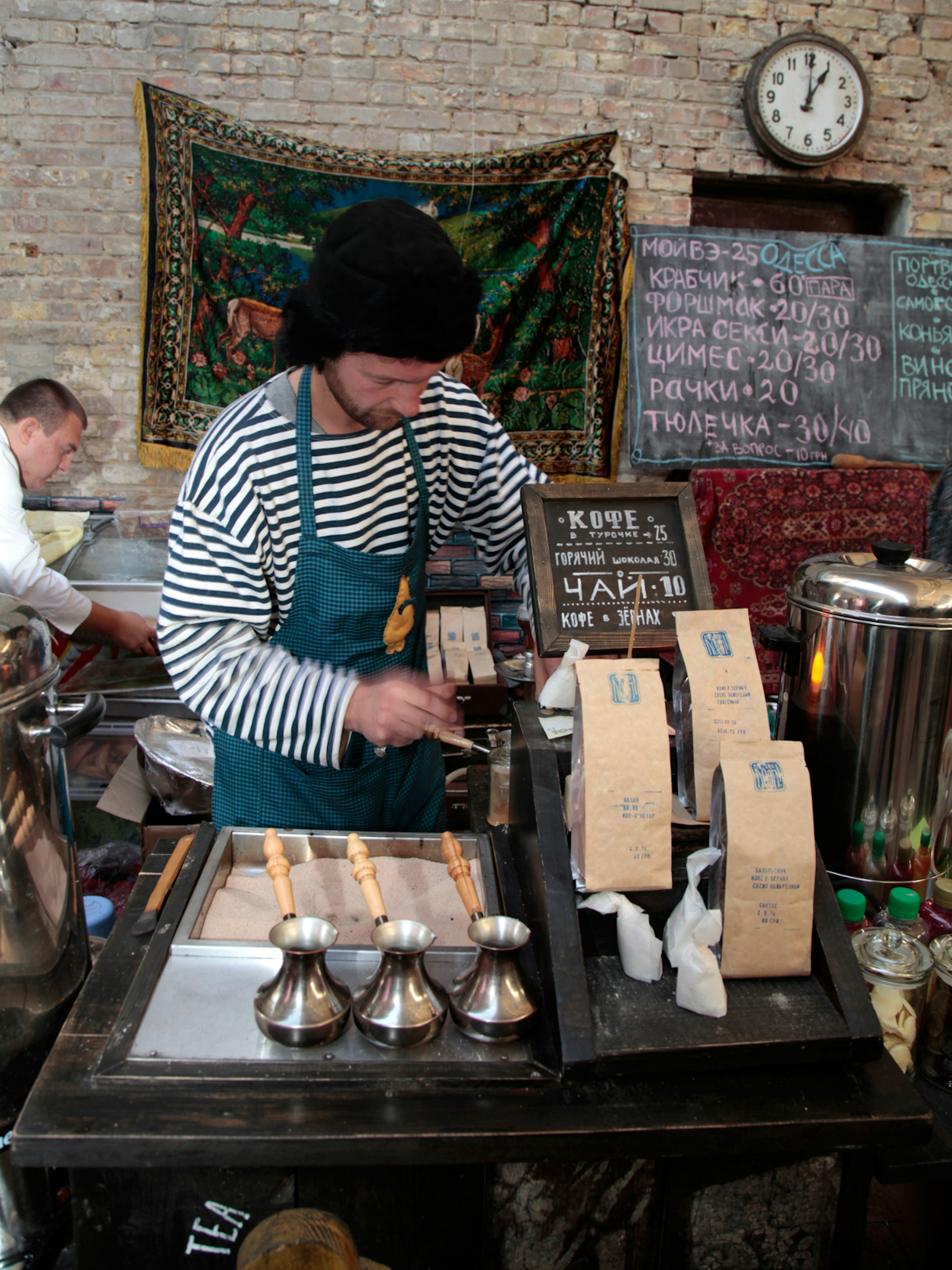 Turkish coffee cooked in a copper pot with hot sand at a food stall during Kyiv's Street Food Festival © InnaFelker / Shutterstock