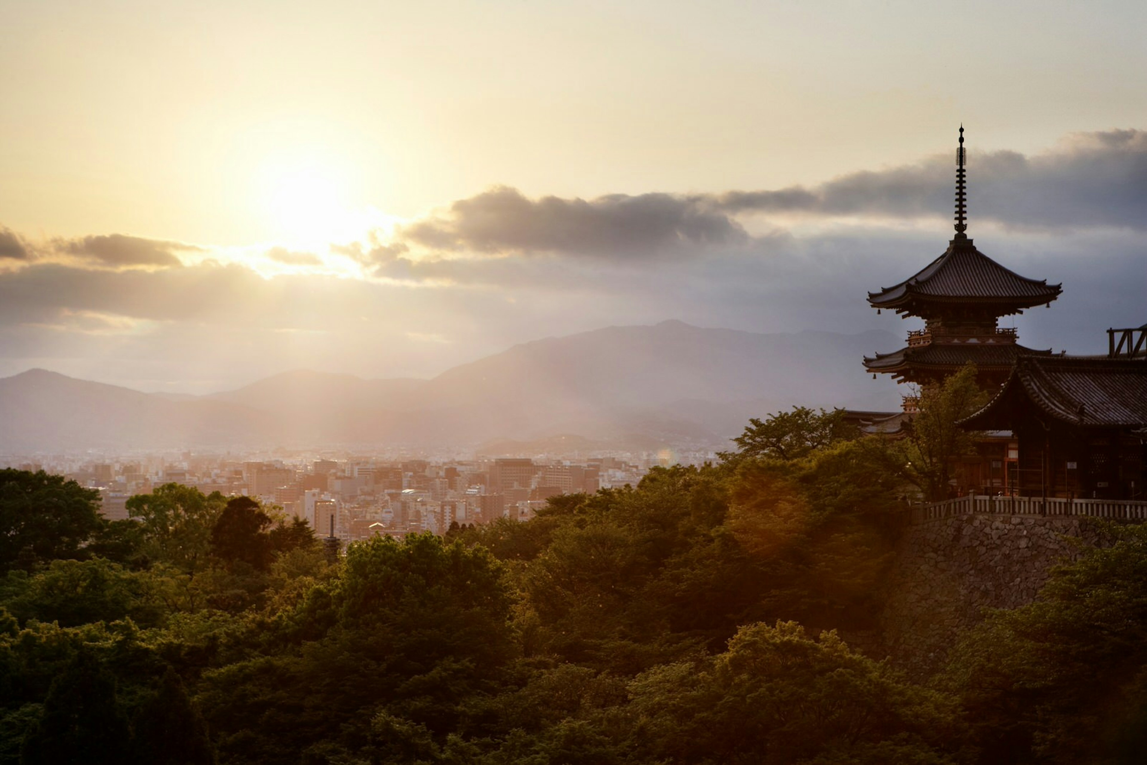 Kyoto glows beneath the early morning light, as seen from the Kiyomizu-dera temple