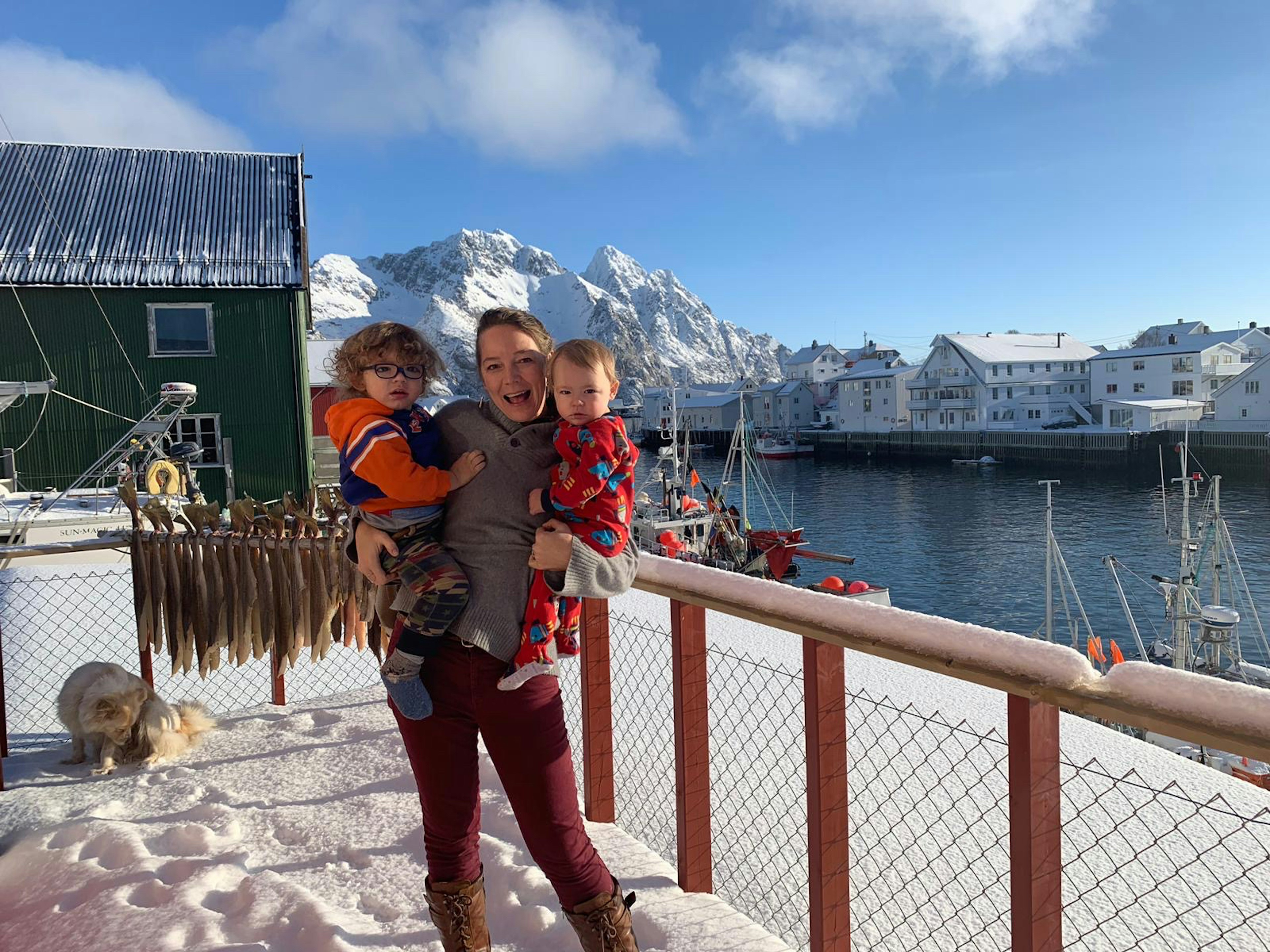 A woman holds her children in the Arctic.