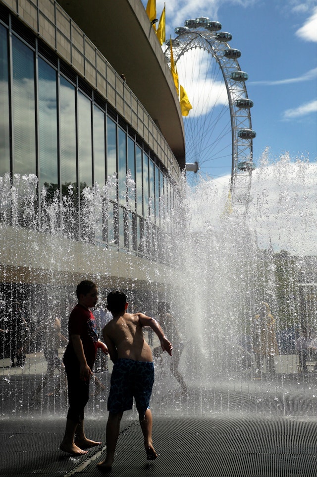 Children splashing in the fountains outside the Royal Festival Hall, London.