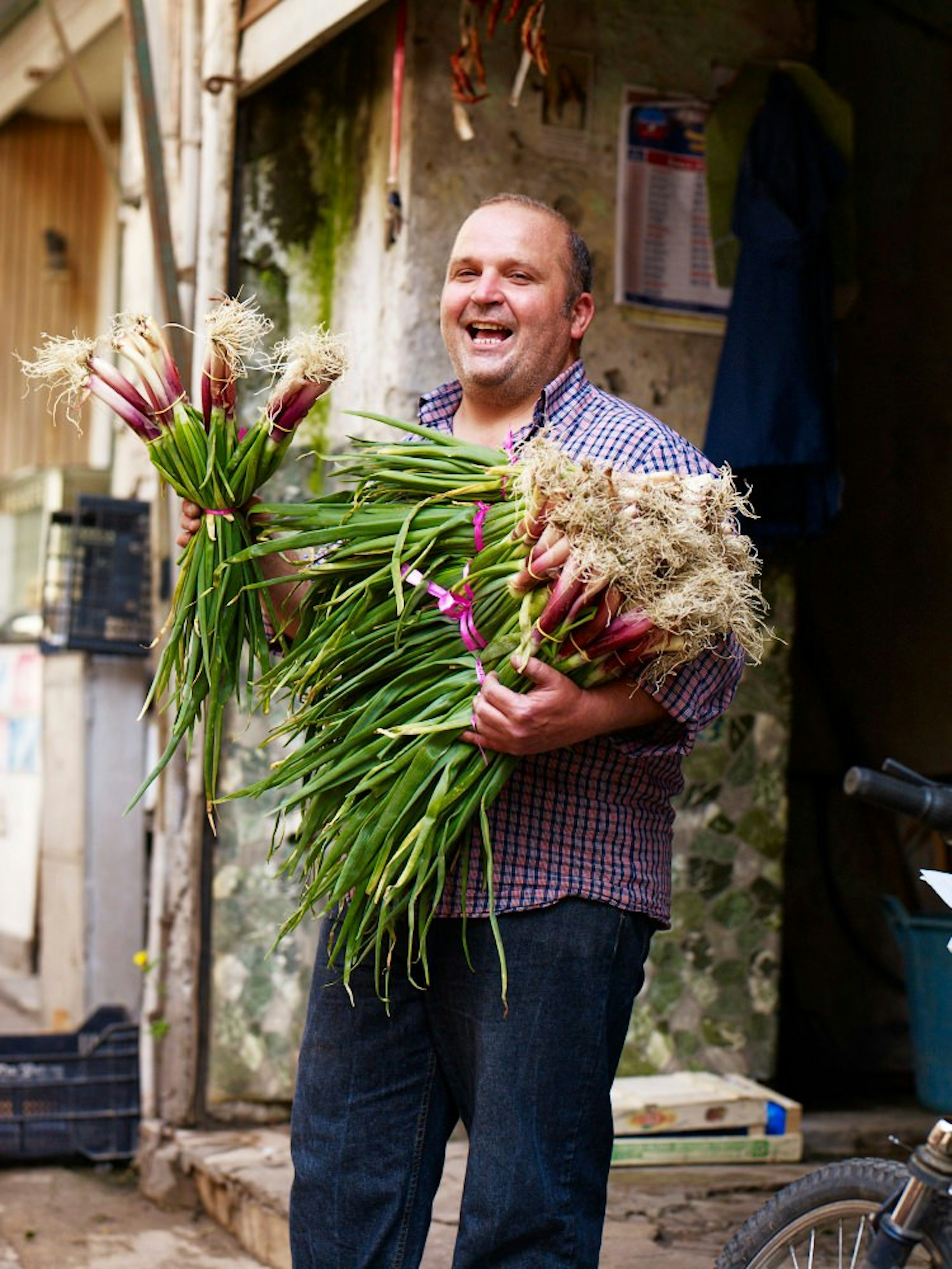 A stallholder at Vucciria market holds some fresh produce