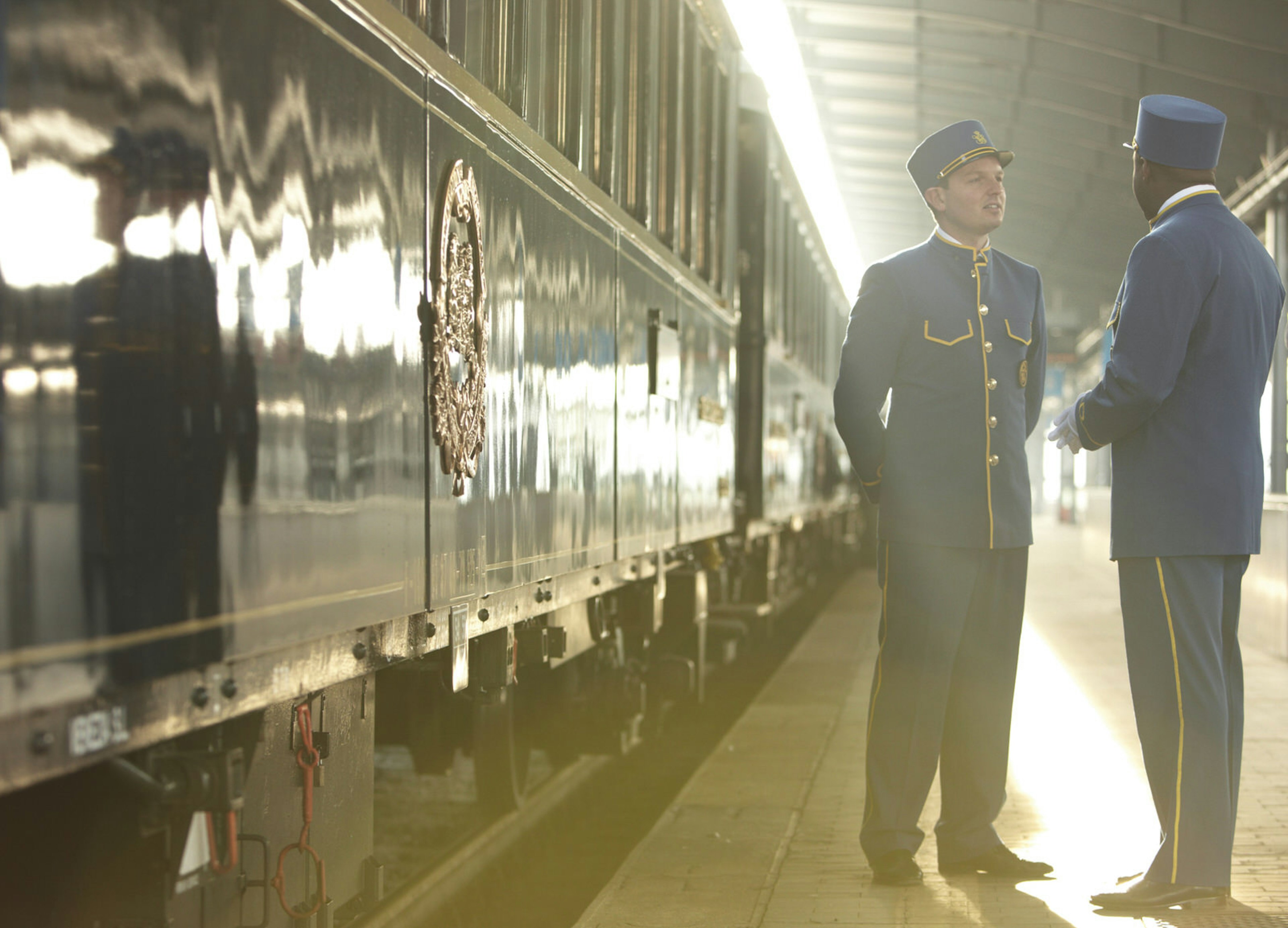 Station attendants beside Orient Express at station