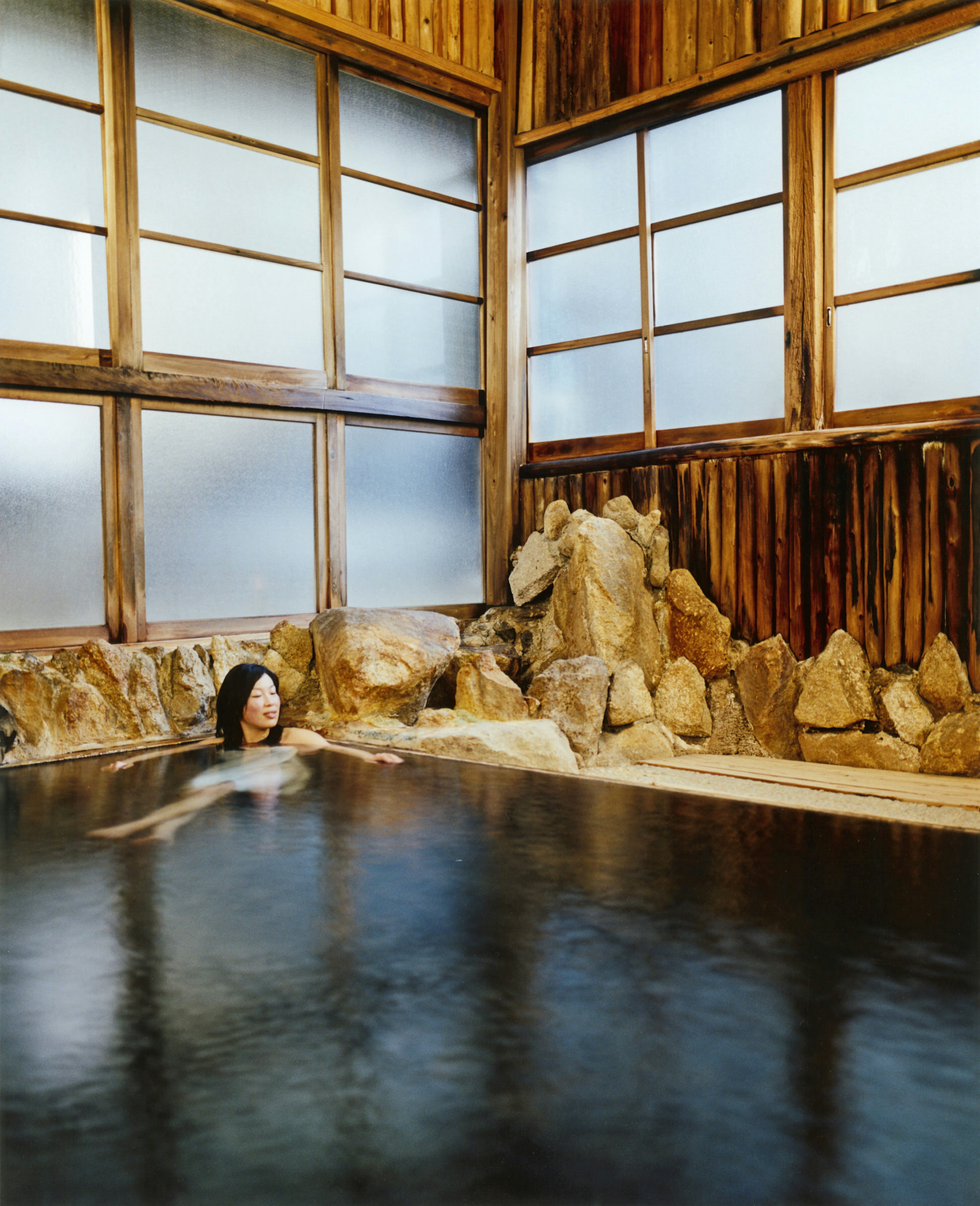 Woman soaking in an onsen at Adumaya Ryokan in Yunomine