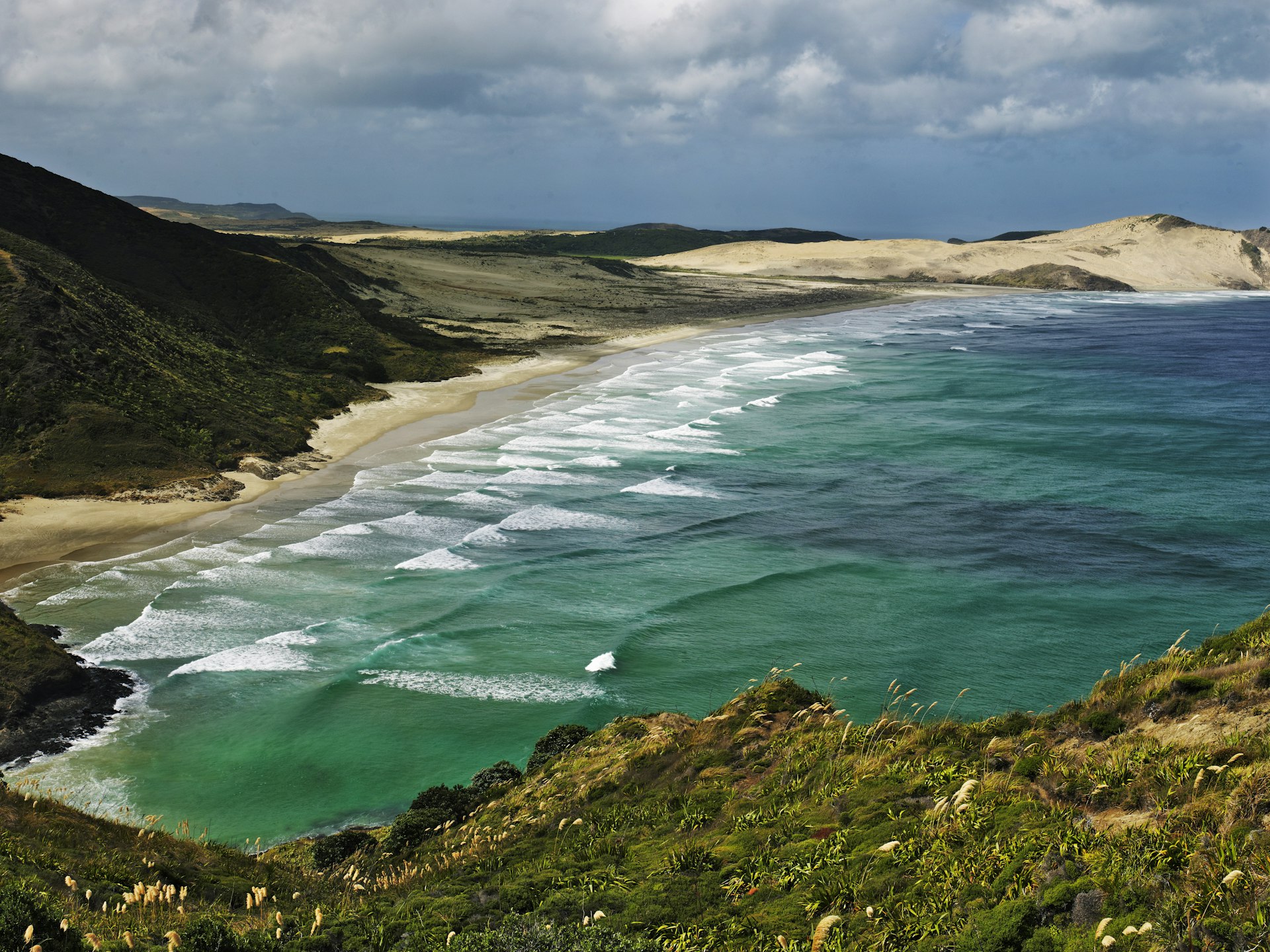 View over Cape Reinga with long beaches and waves.