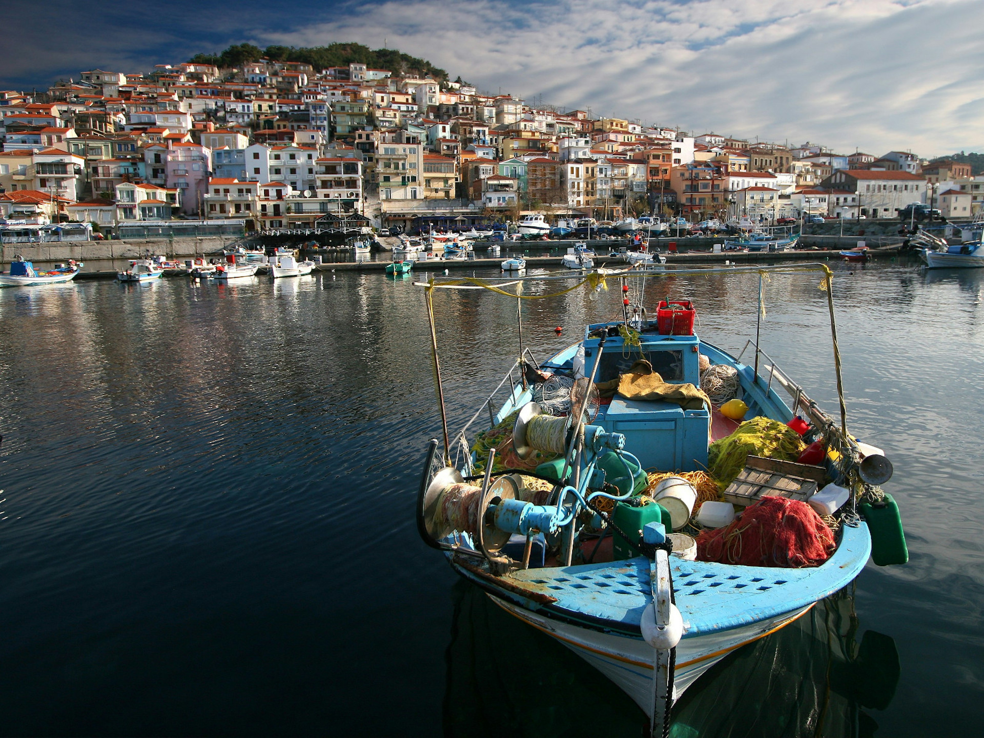 A fishing boat laden with nets in the harbor in Lesvos, Greece