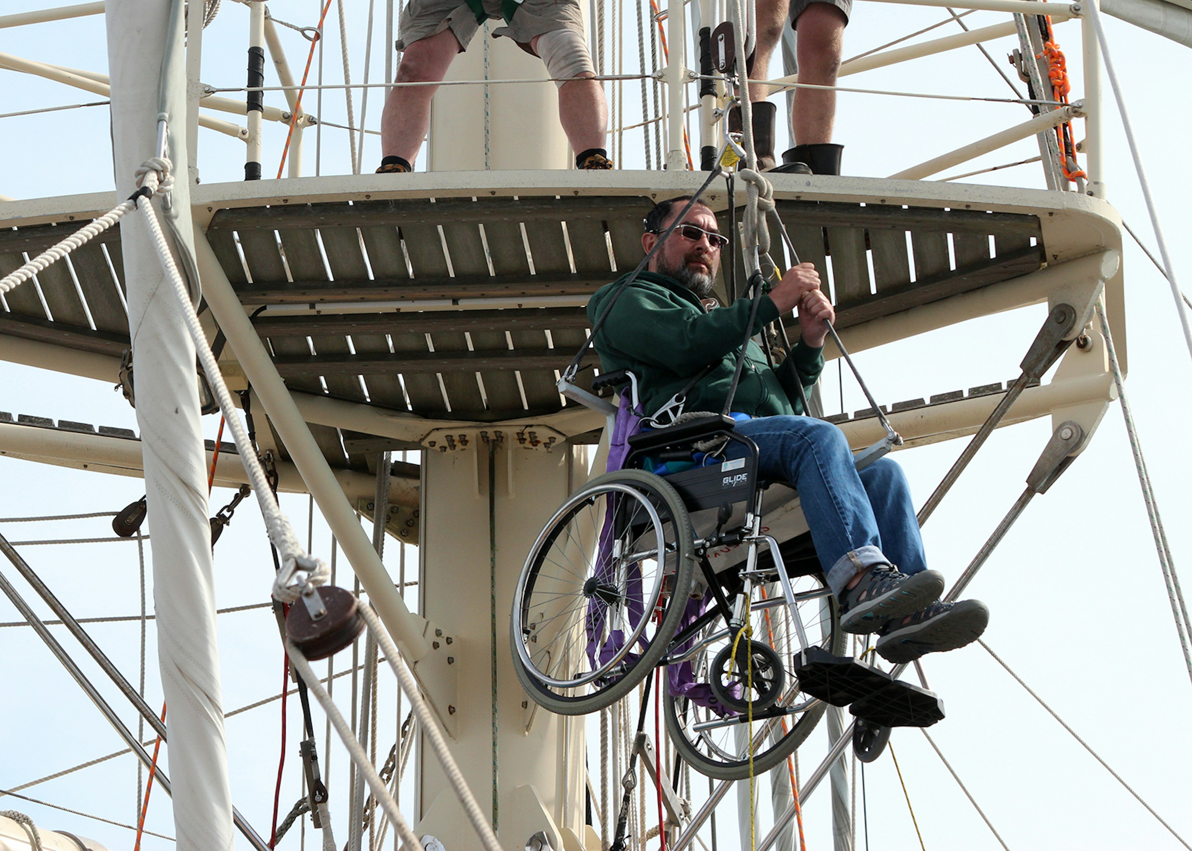 Martin Heng is hoisted to the crow's nest, 10m above the deck of the SV Tenacious