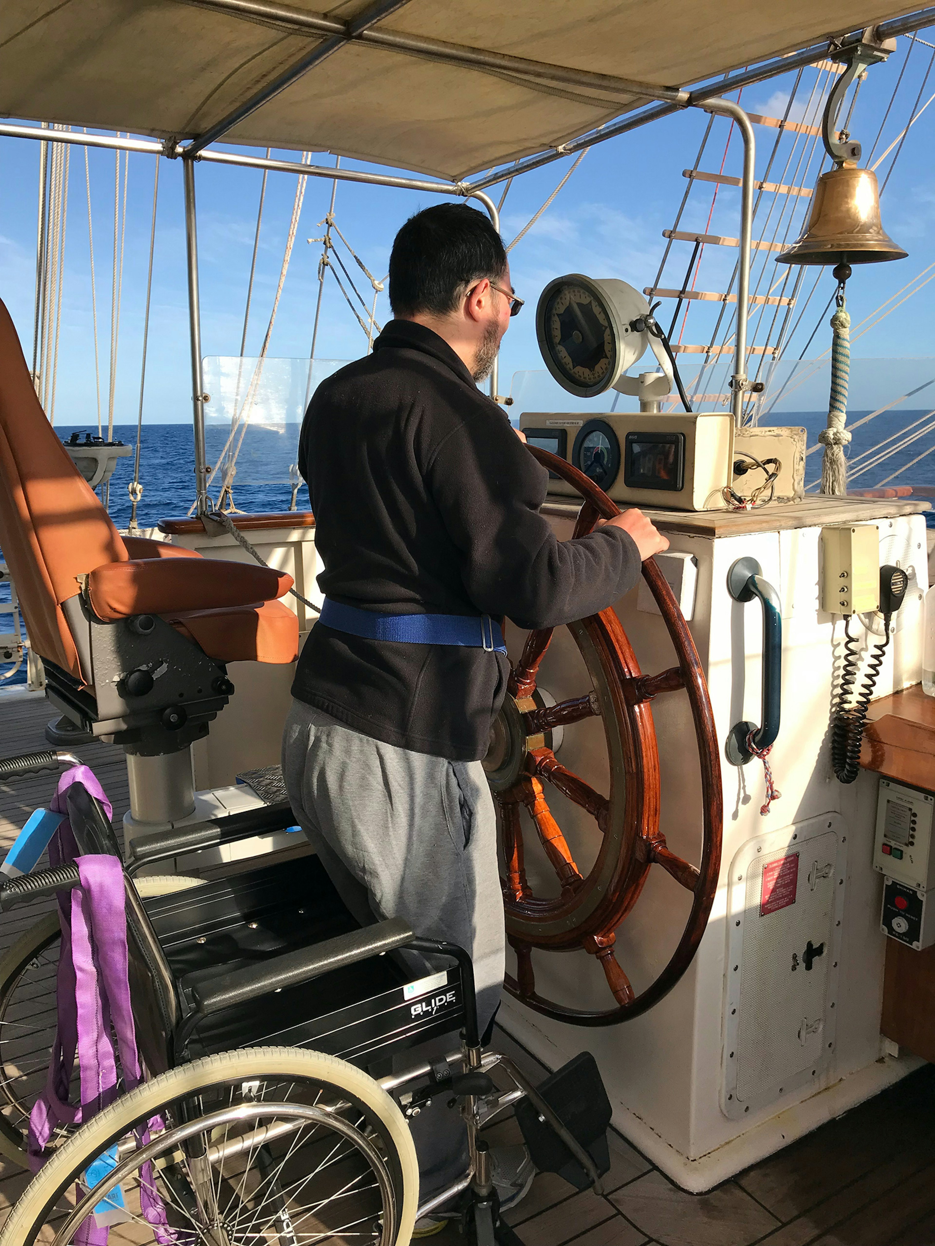 Martin Heng takes the wheel of the SV Tenacious / Image supplied by Martin Heng