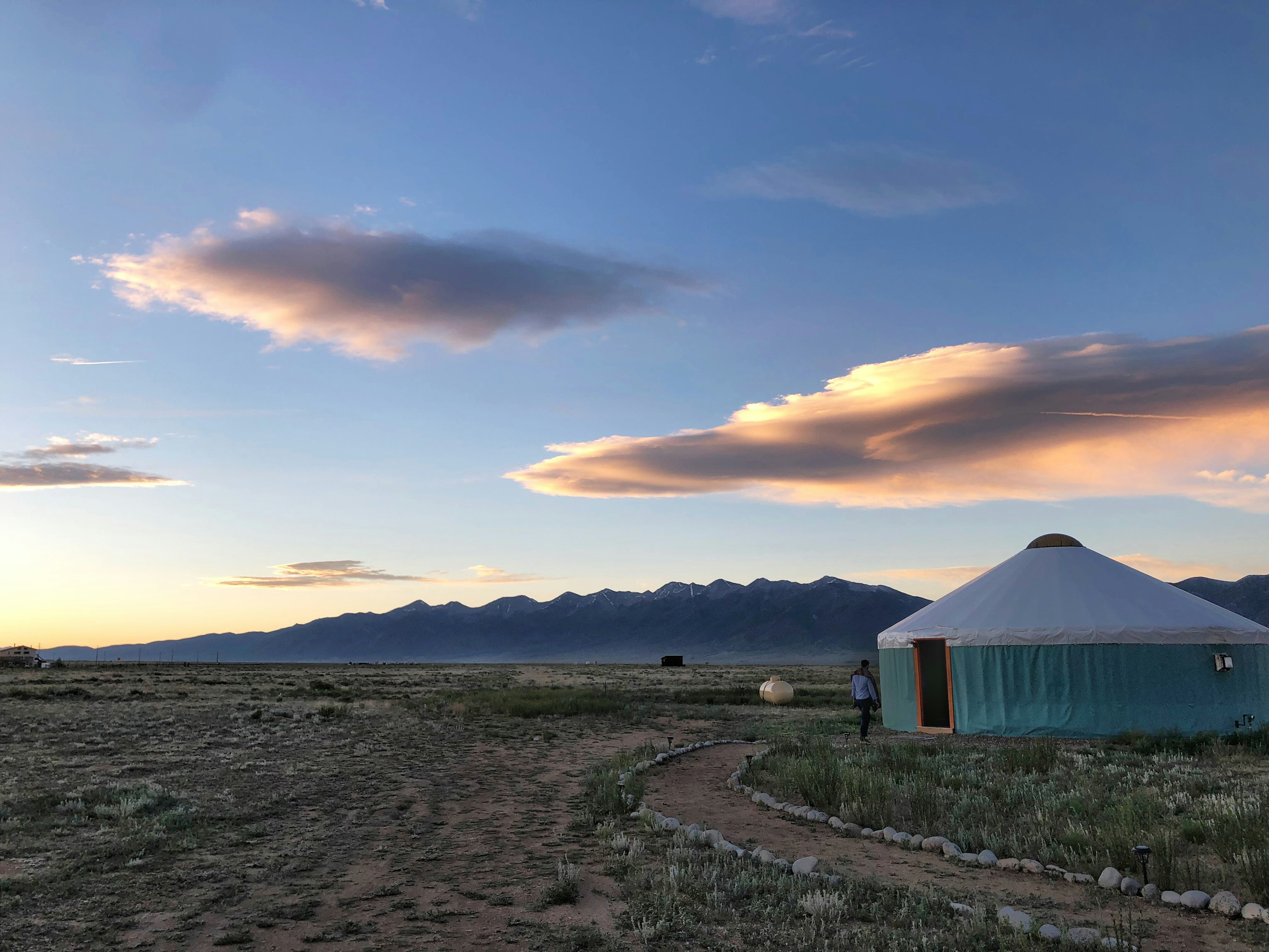 A yurt with mountains in the background