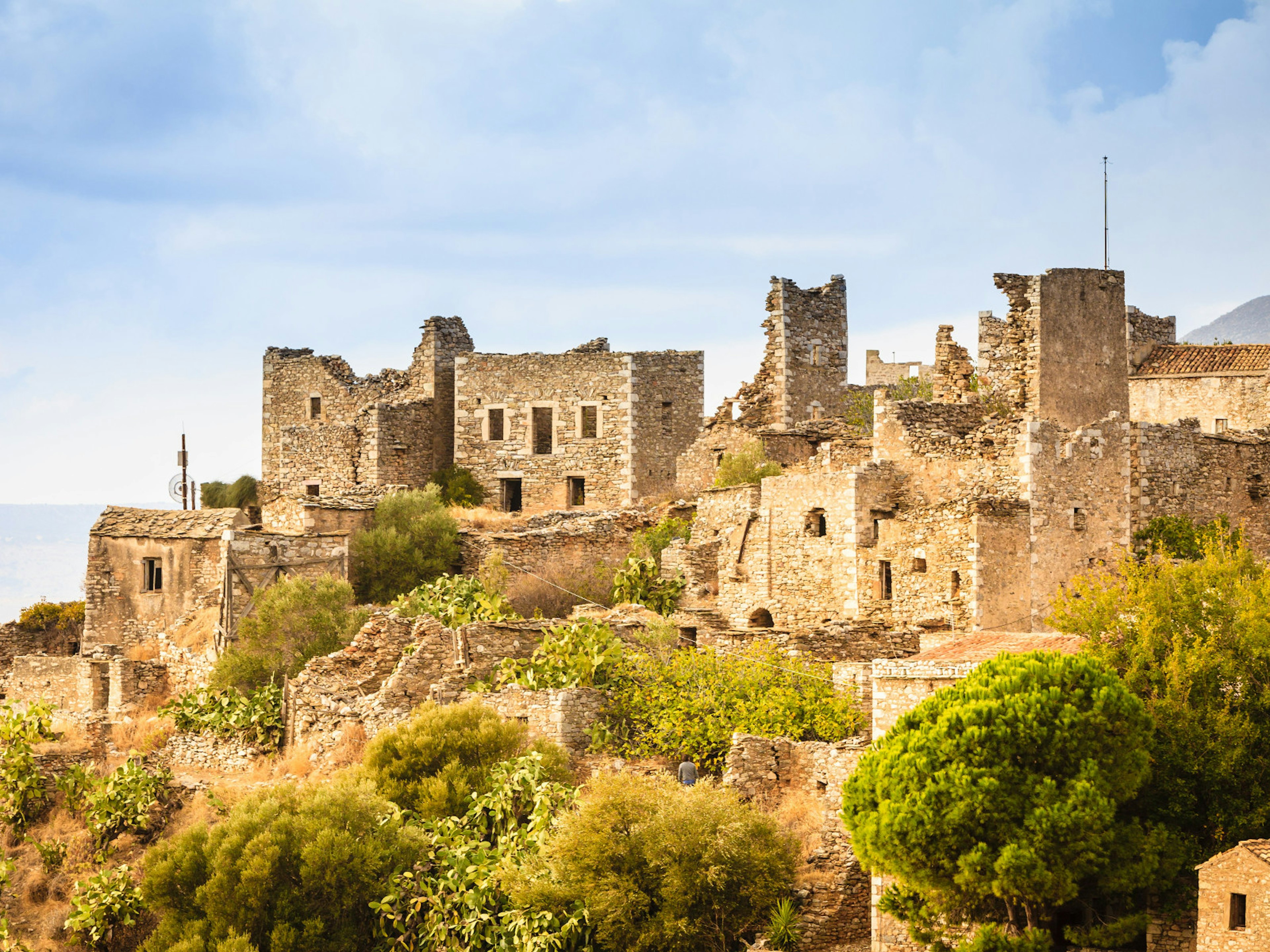 Abandoned tower houses stand in Vathia on the Mani peninsula in the Peloponnese © Voyagerix / Shutterstock