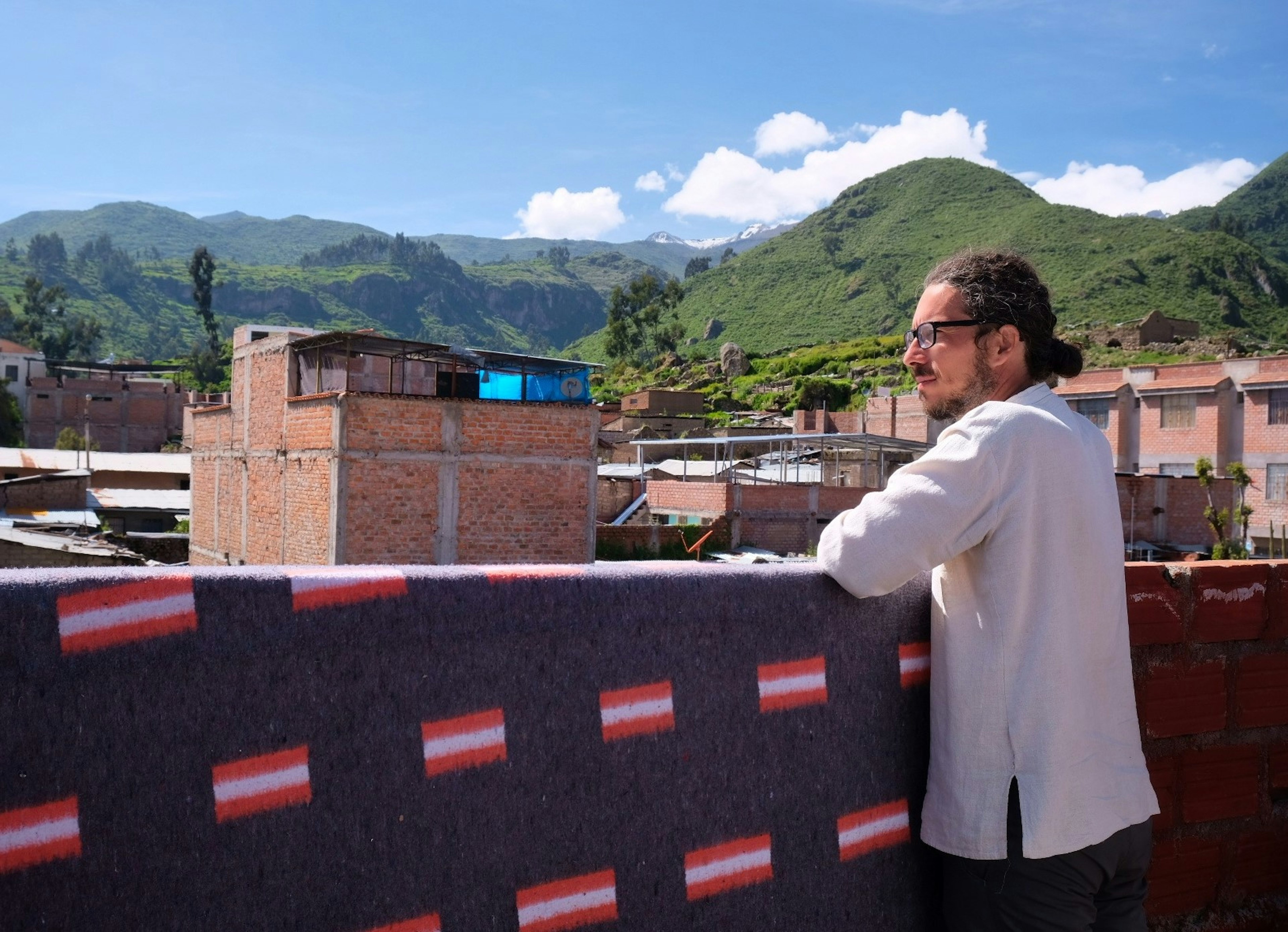 Travel writer Marco Ferrarese surveys the surrounds of Cabanaconde in Peru from the rooftop of his hostel accommodation.