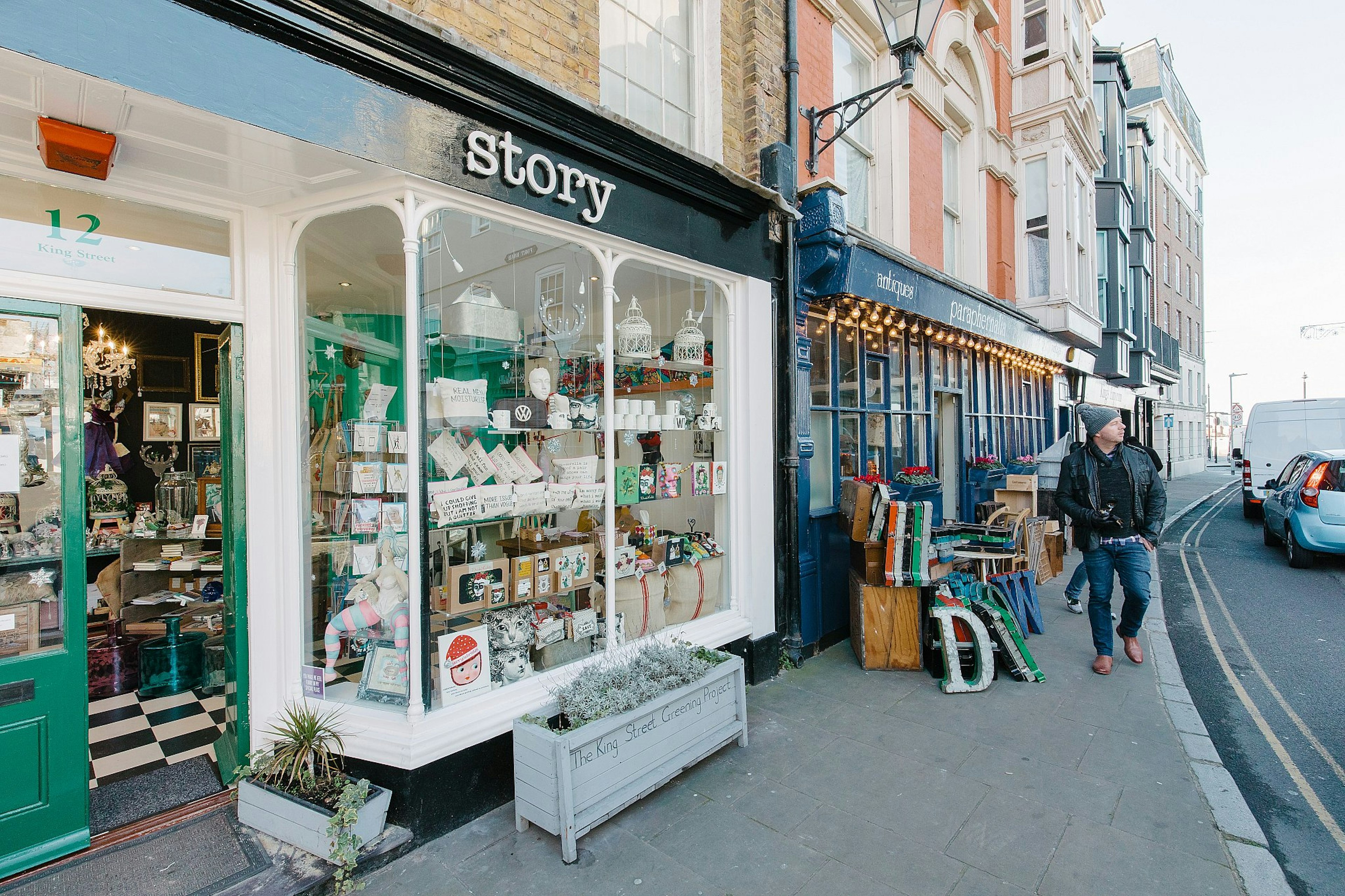 A man walks down a street of attractive Victorian shops in Margate Old Town.