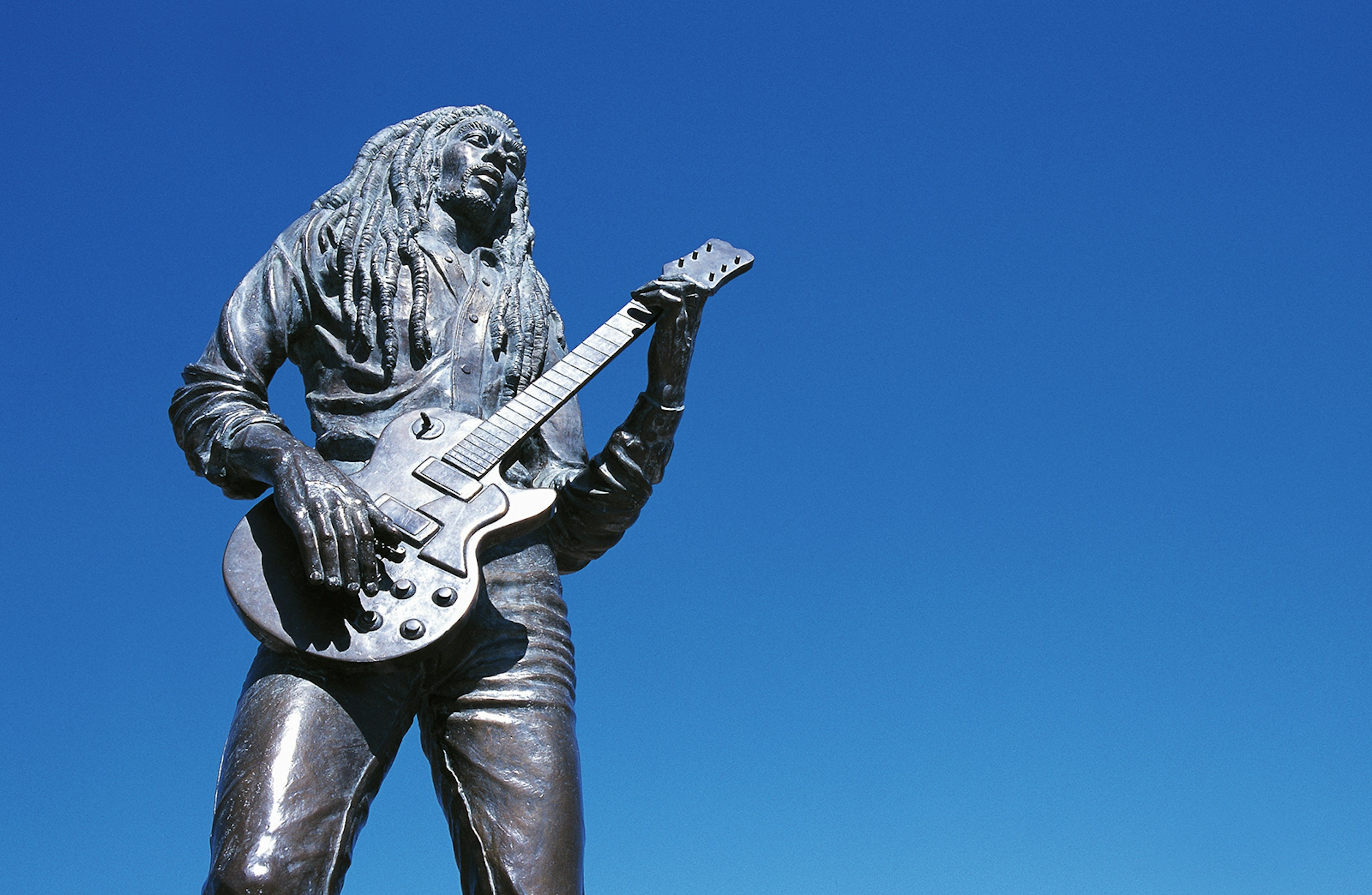 Statue of Jamaican reggae singer and musician Bob Marley (1945-1981), Kingston, Jamaica.
621703543
no people, horizontal, outdoors, day, low angle view, copy space, human representation, male likeness, clear sky, capital cities, travel destinations, music, history, the past, art and craft, art, statue, sculpture, jamaica, kingston, bob marley, guitar, reggae, singer, musician