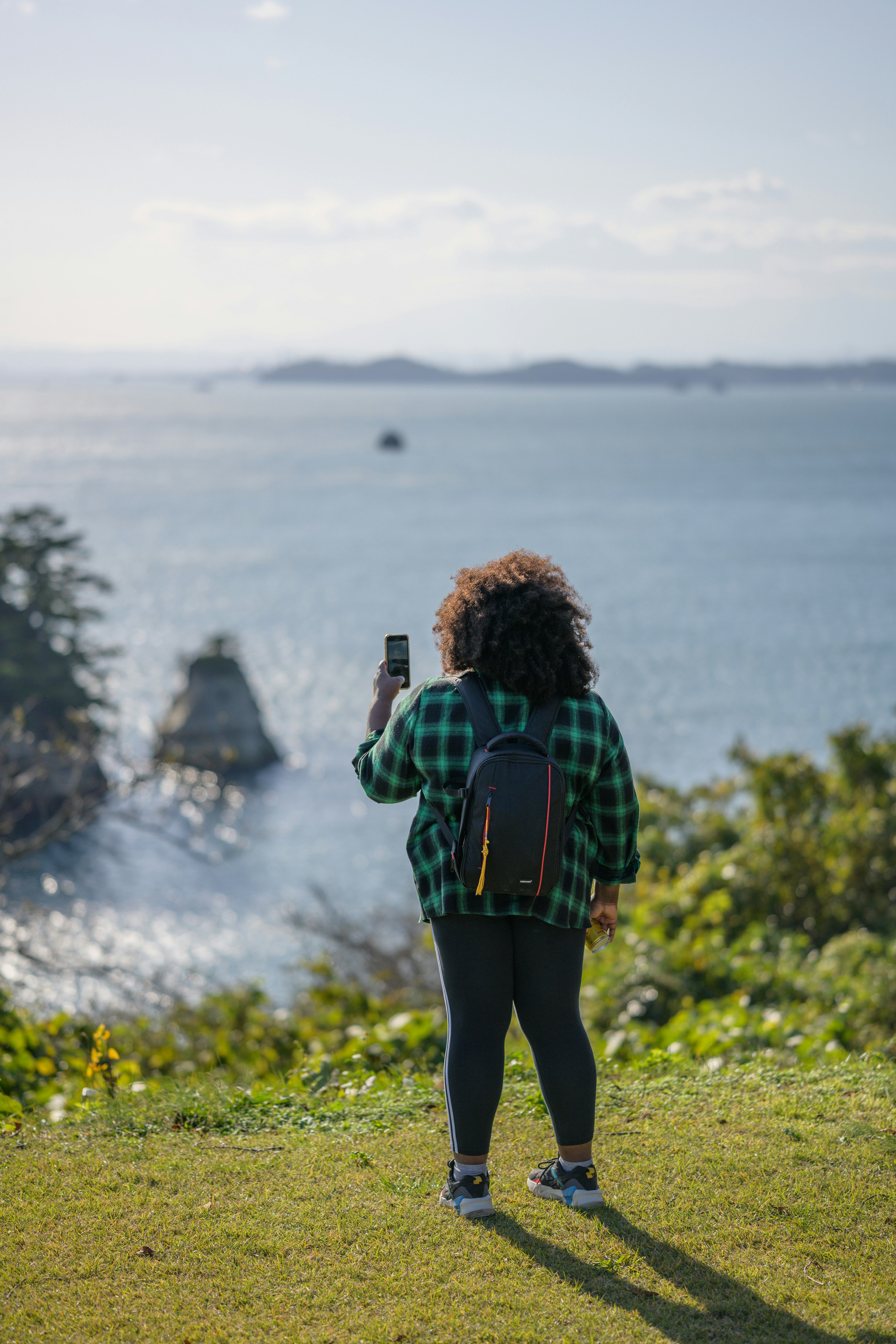 Steph takes photos of the beautiful views on her phone.