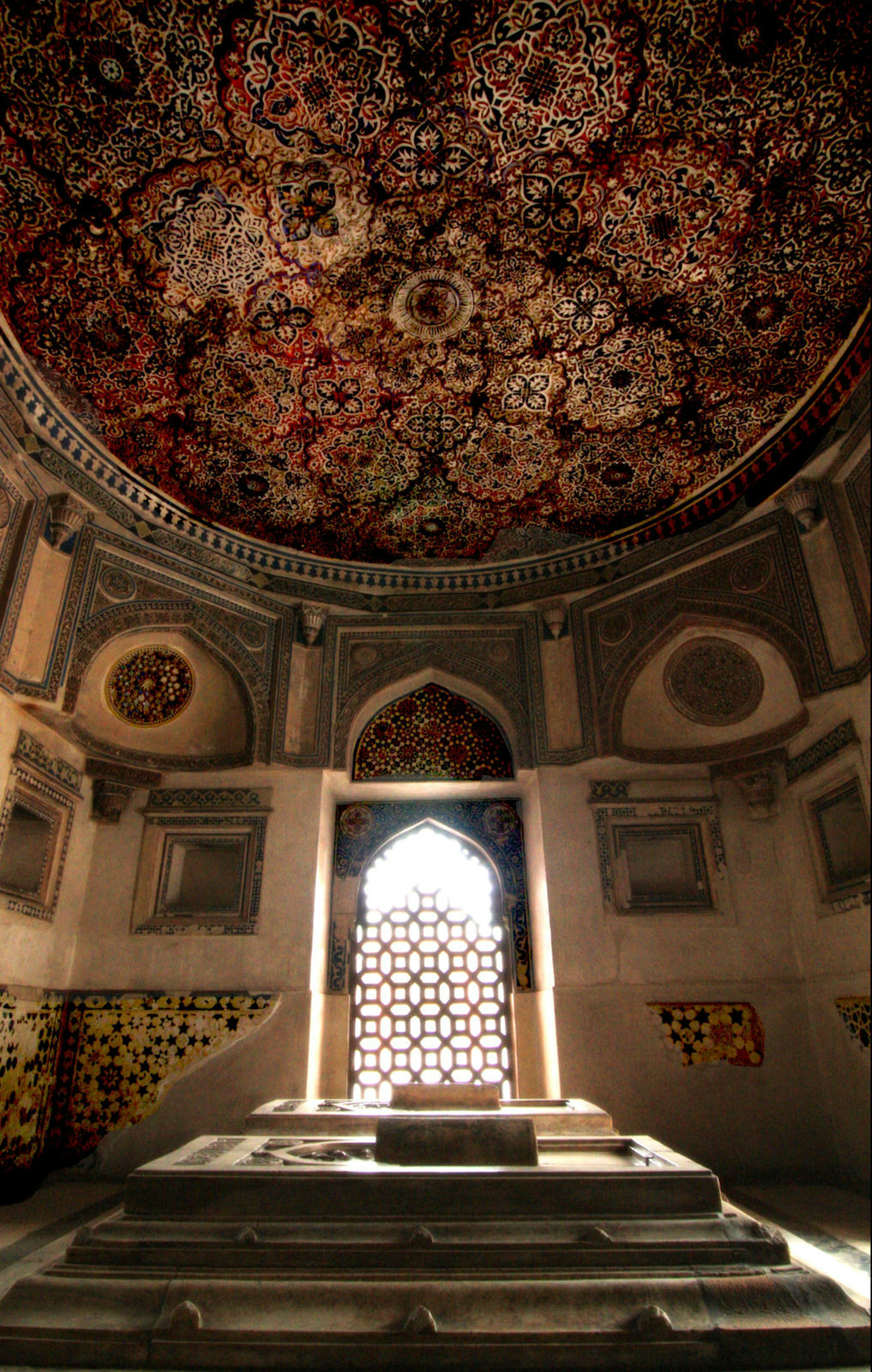 Ornate roof inscriptions in a shady tomb at the Mehrauli Archaeological Park