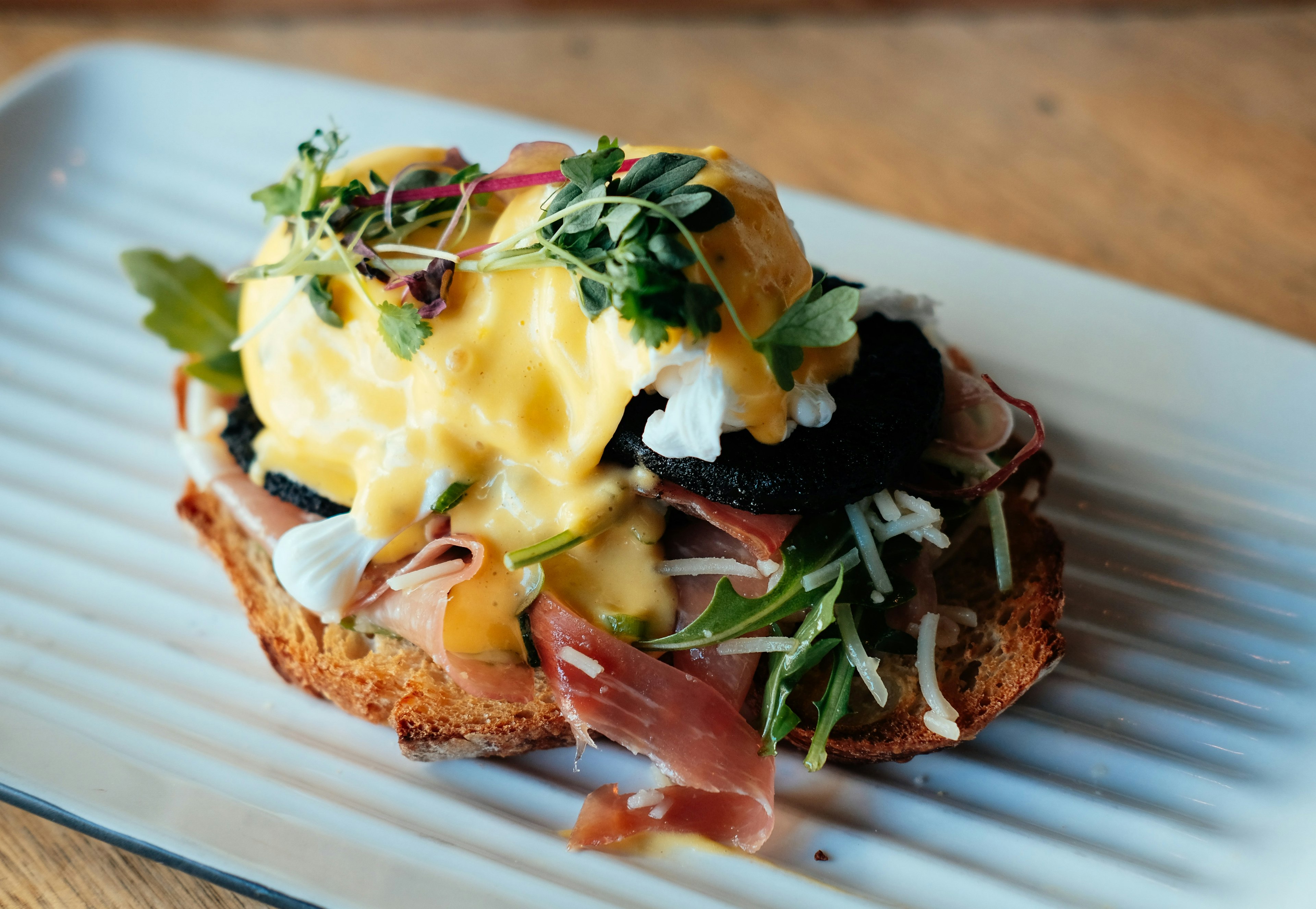 Eggs Benedict, served on a crusty piece of bread, in a cafe in Melbourne, Australia.