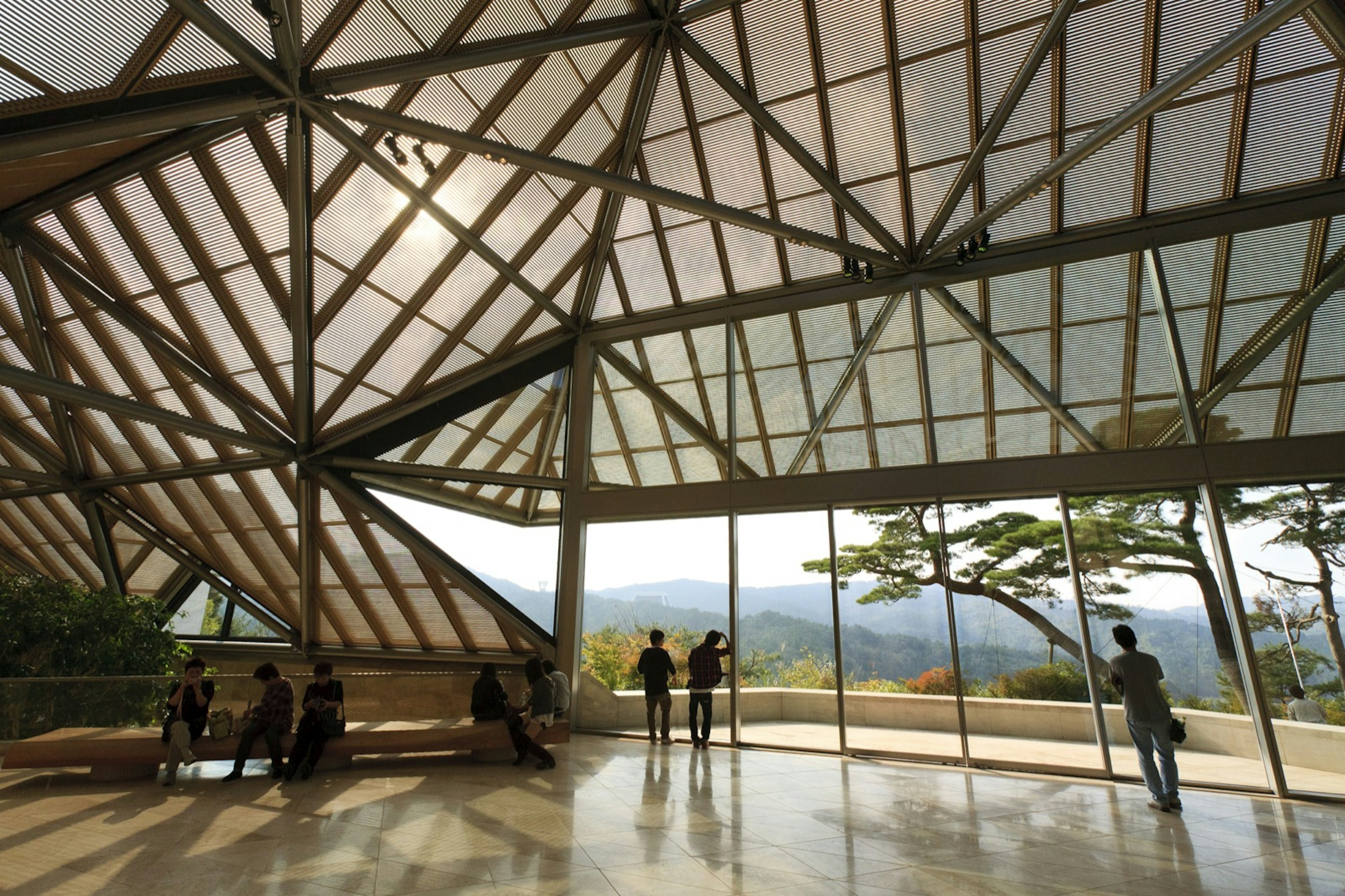 People enjoy the space while looking out onto a verdant green valley