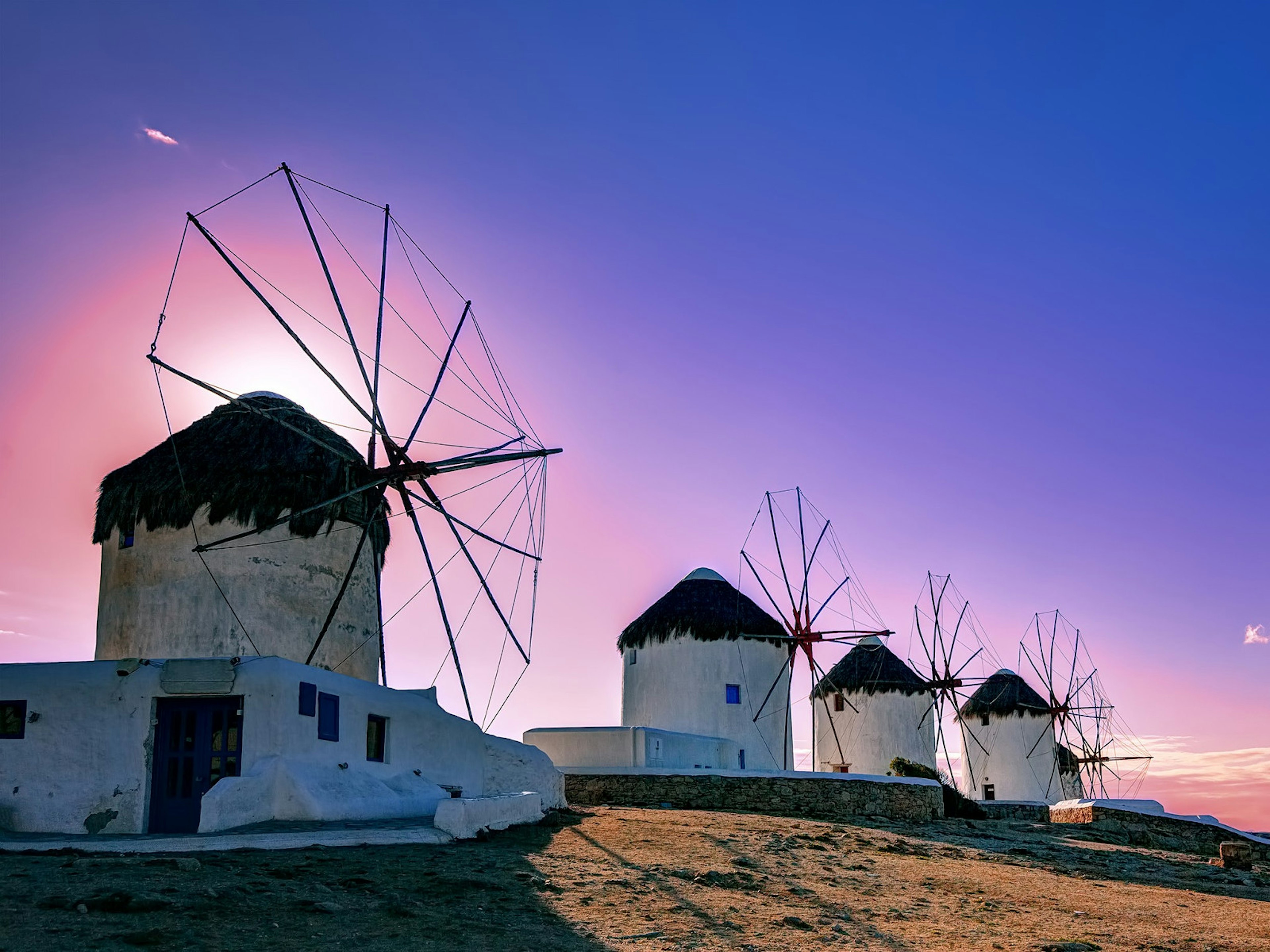 Traditional windmills are a symbol of the LGBT and jetsetter’s paradise island of Mykonos © Lemonakis Antonis / Shutterstock