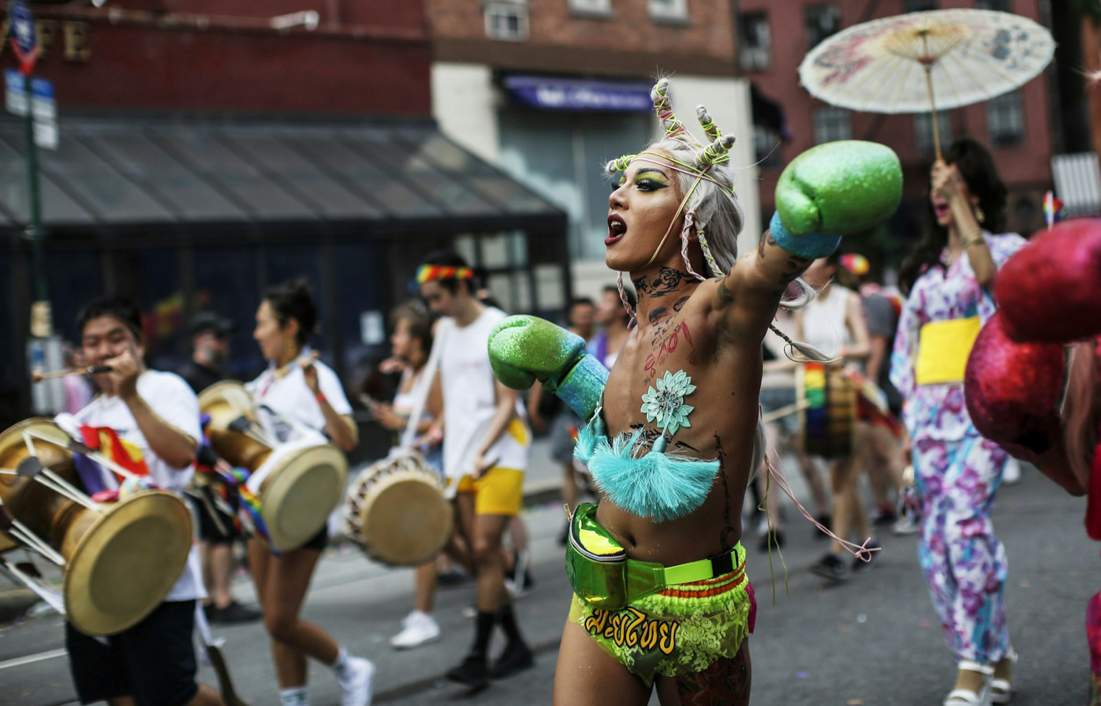 A New York Pride reveler wearing neon green lace hot pants, green glitter boxing gloves and turquoise pasties marches in the New York City Pride parade. NYC WorldPride is expected to attract 6 million people.