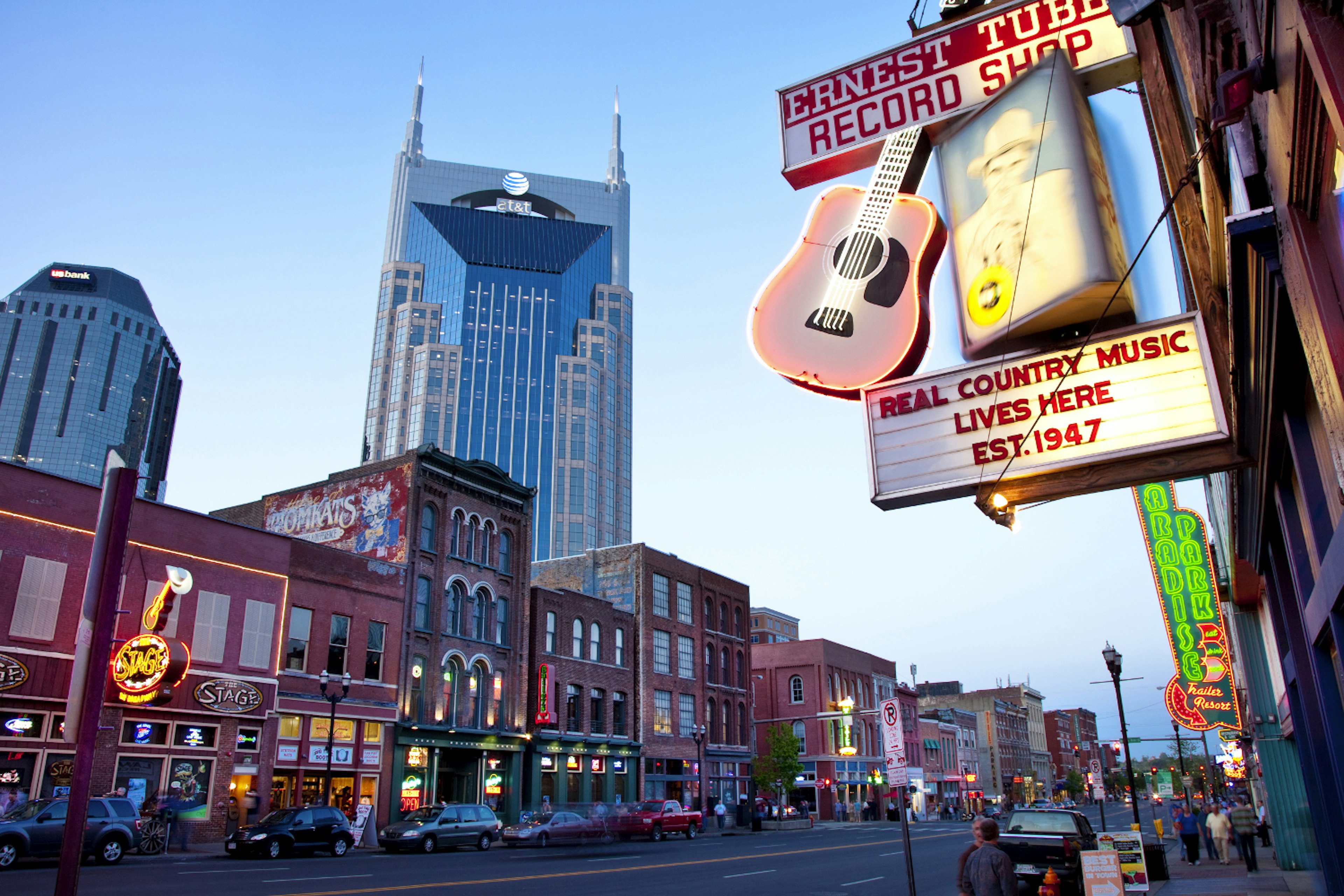 The AT&T building towers over the historic bars and honky-tonks along lower Broadway in Nashville Tennessee USA