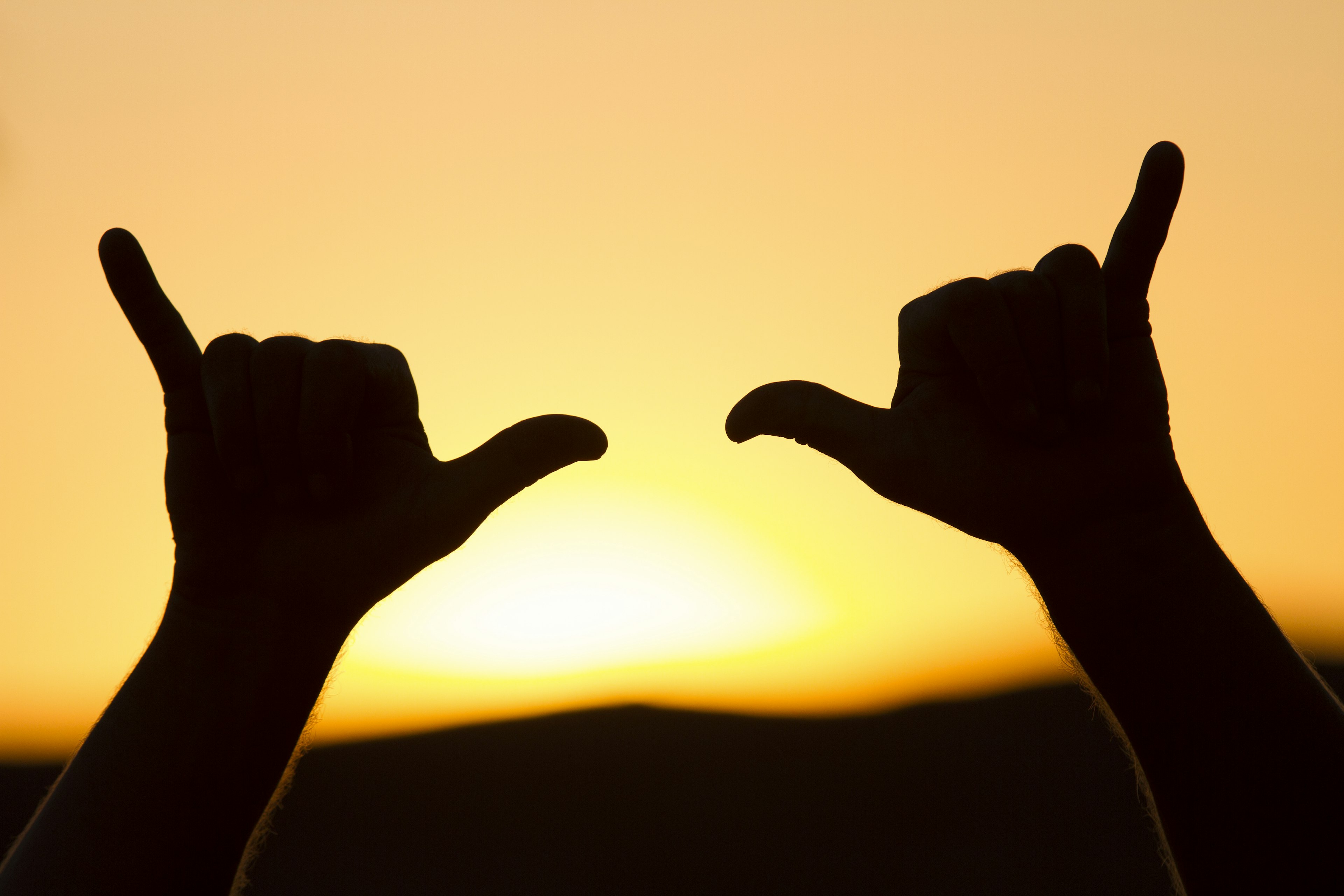 The typical 'finger-and-thumb' hand gesture that's used as a greeting in Polynesia