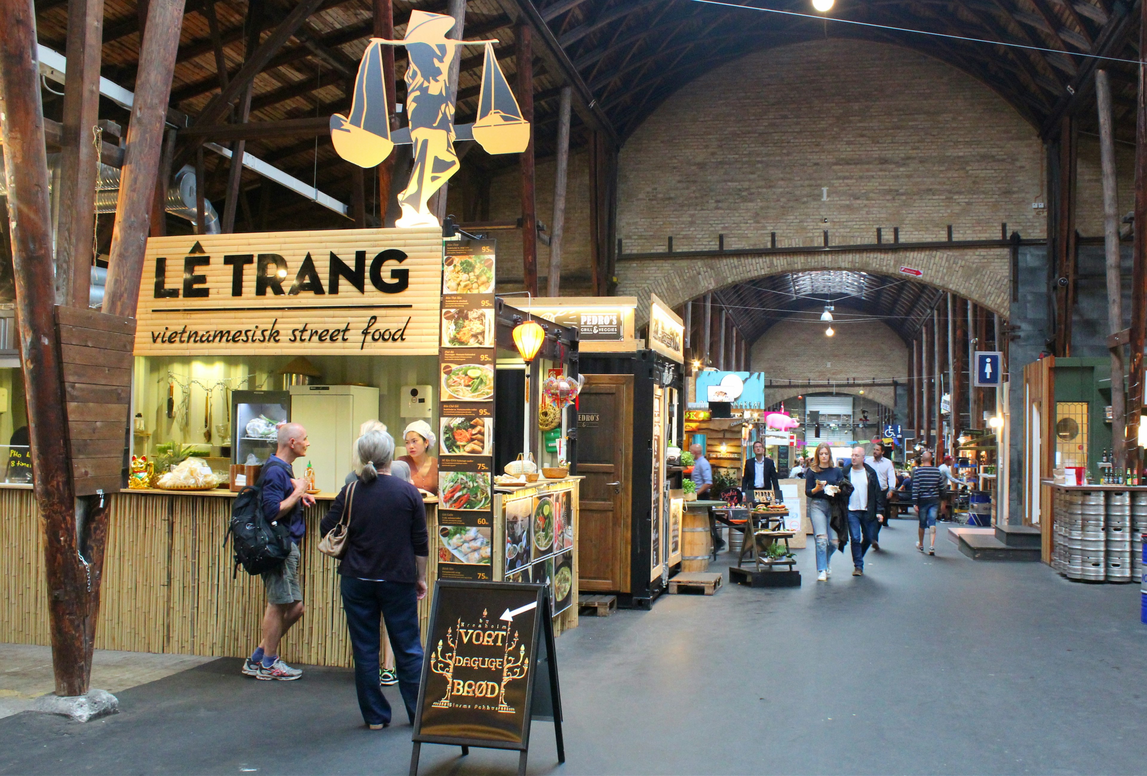 Inside Odense Street Food at Storms Pakhus; there are several food stalls, including a Vietnamese street food stand.