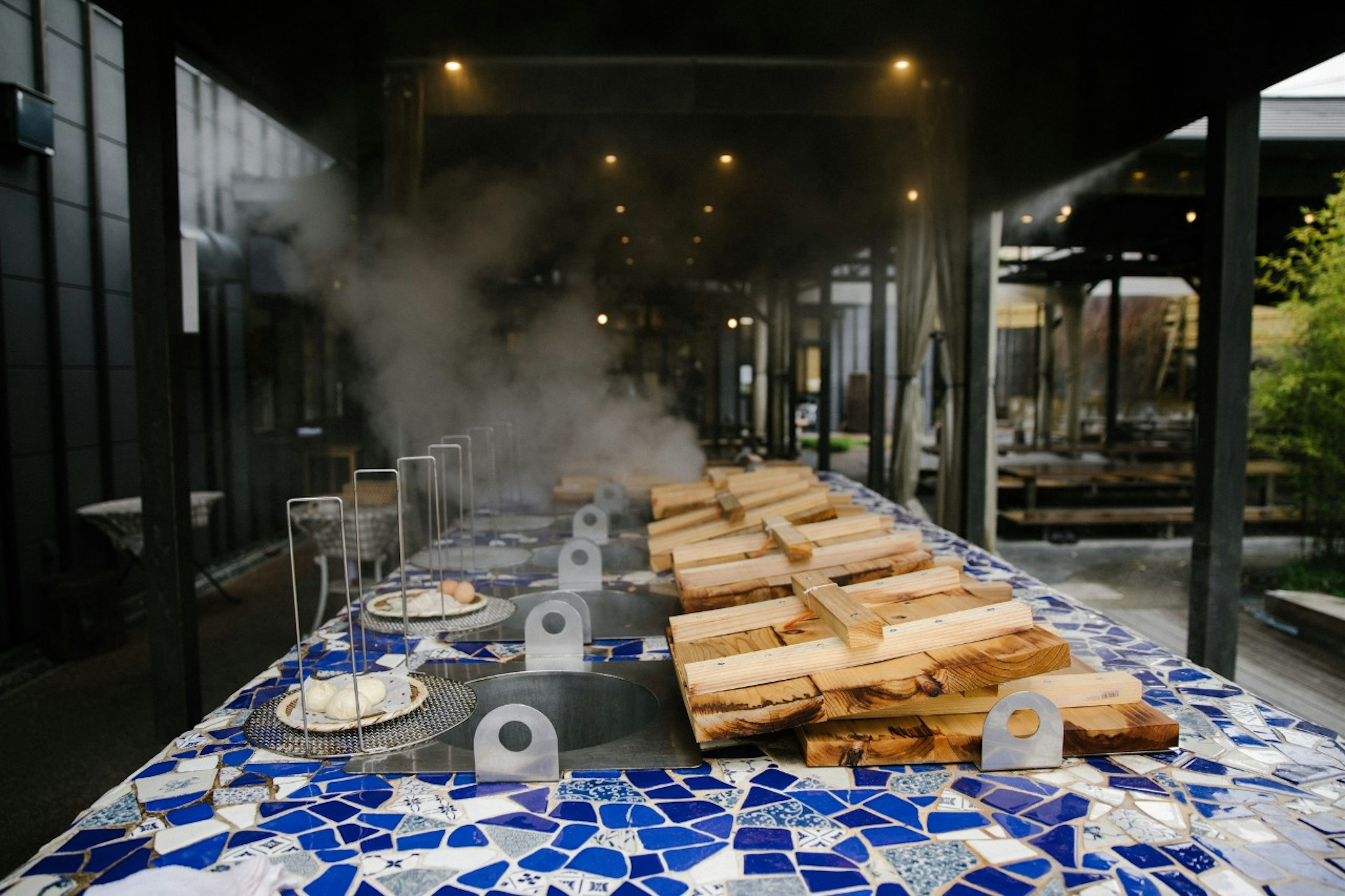 A traditional onsen kitchen with multiple steam pots for cooking food