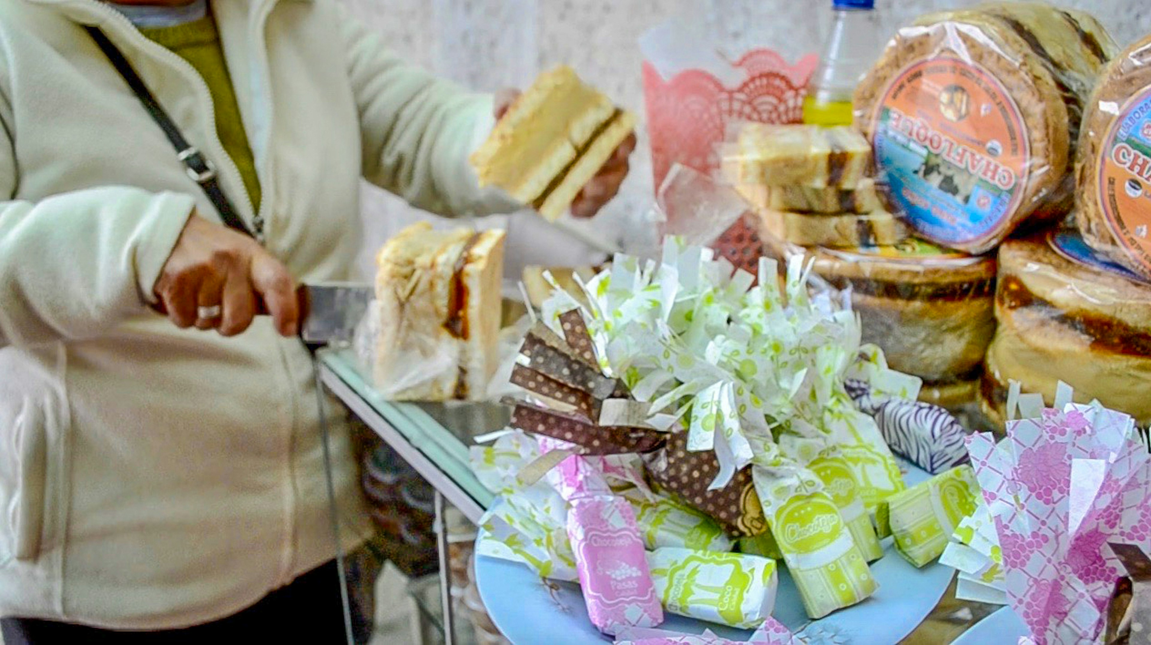 A woman cuts a dessert in Peru