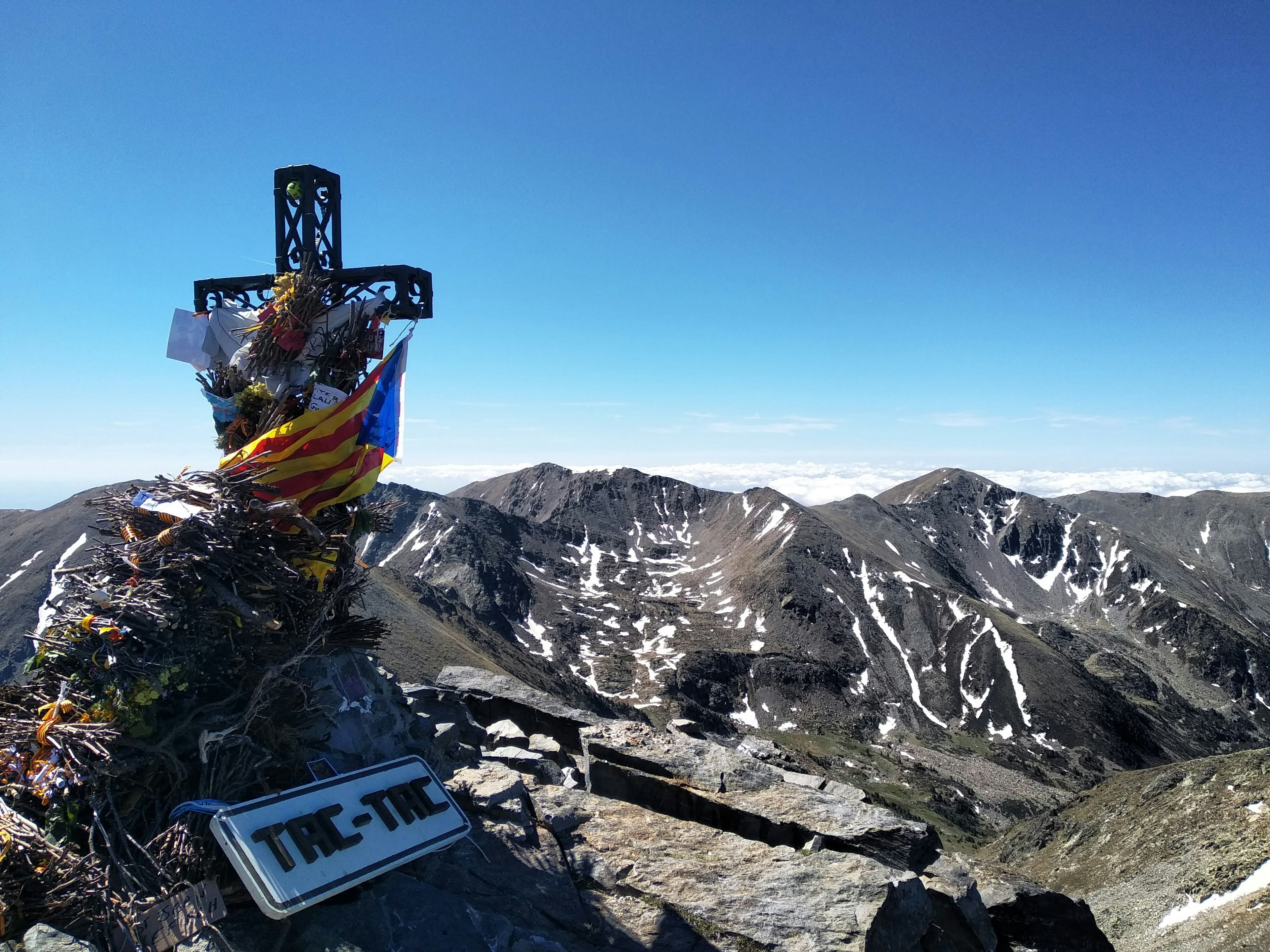 The Peak of Canigou, with a large crucifix crowning mountain scenery.