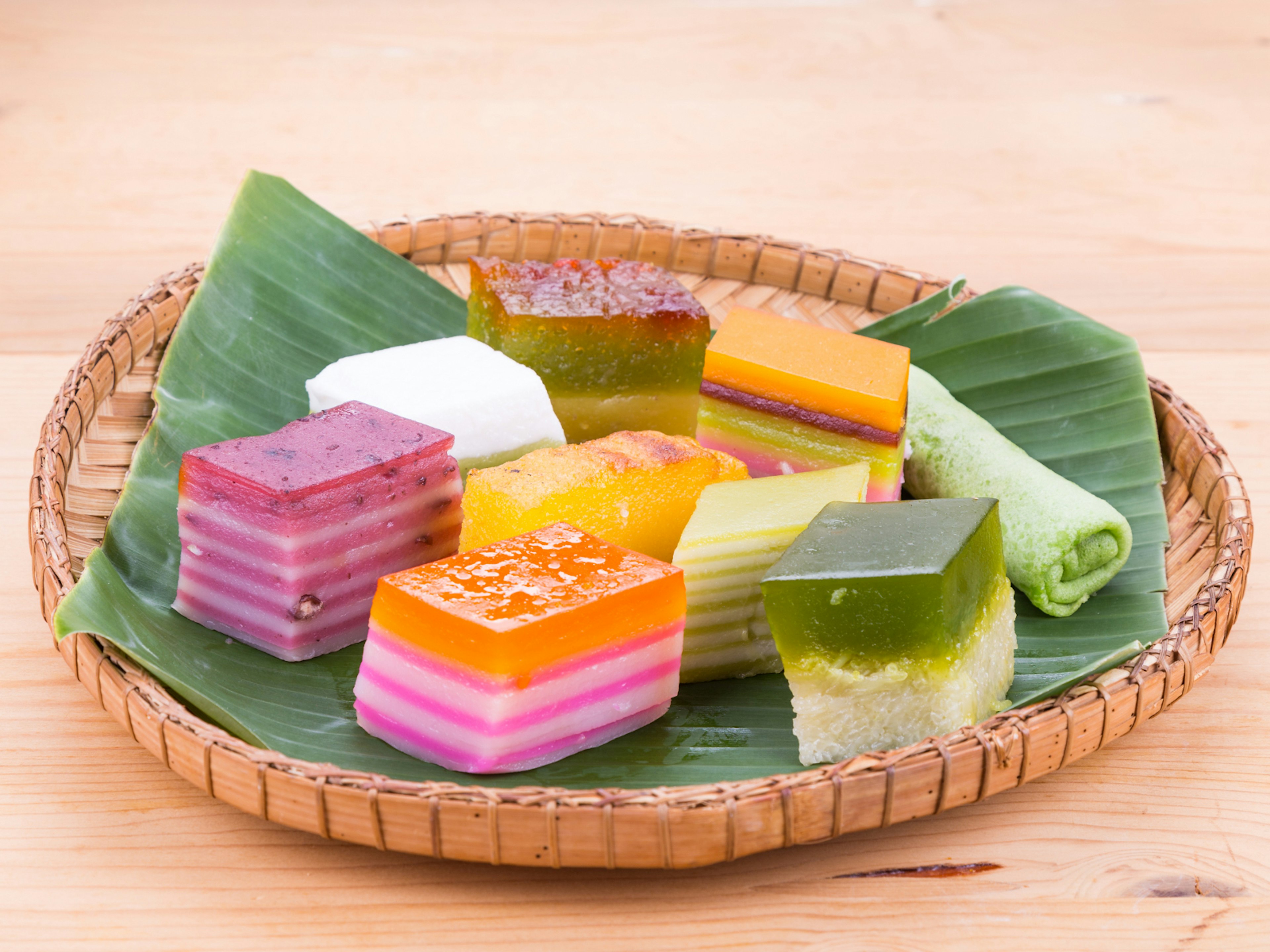 Assorted brightly coloured Peranakan rice cakes known as kueh