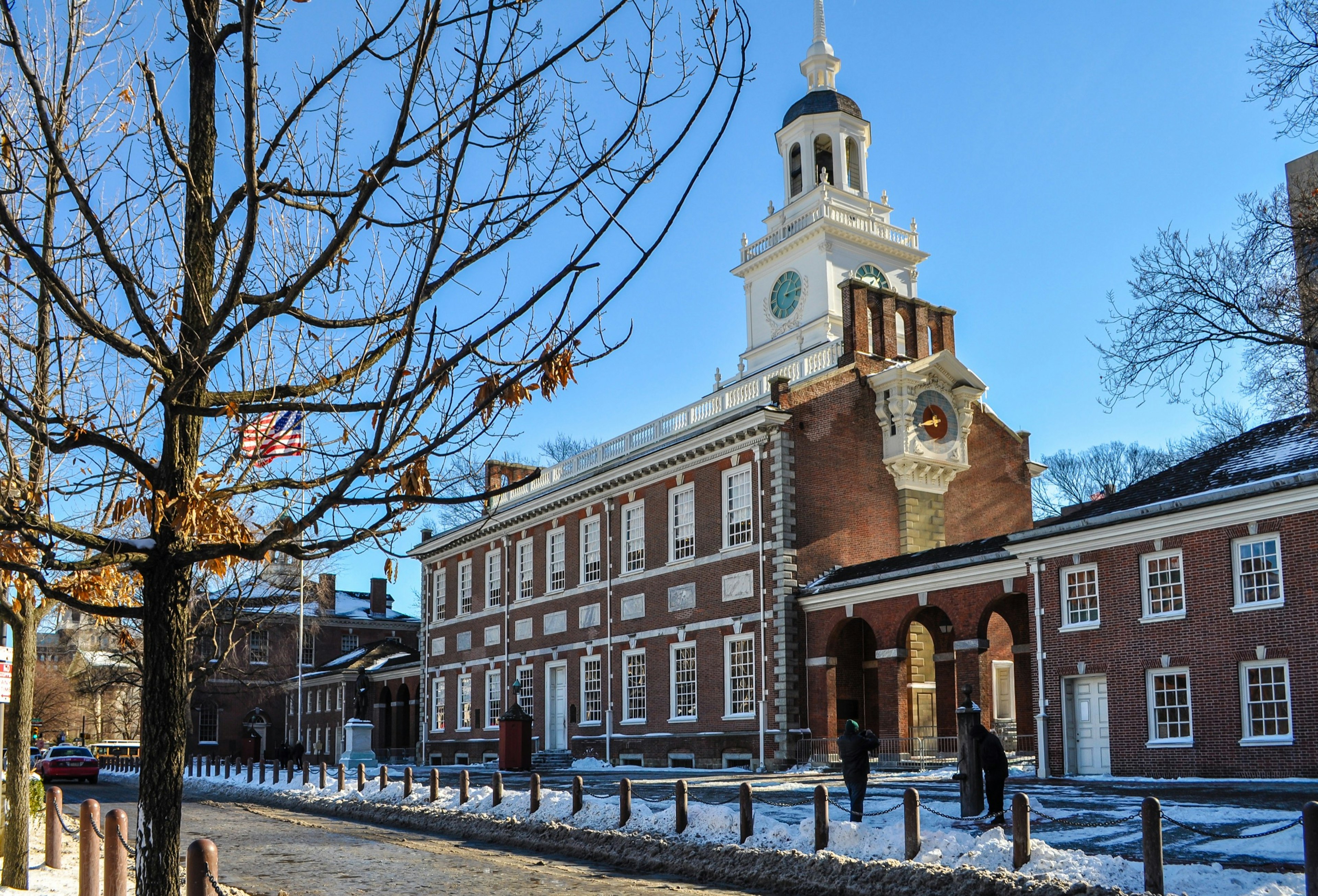 Snow blankets the ground around leafless trees at Independence Hall in Philadelphia