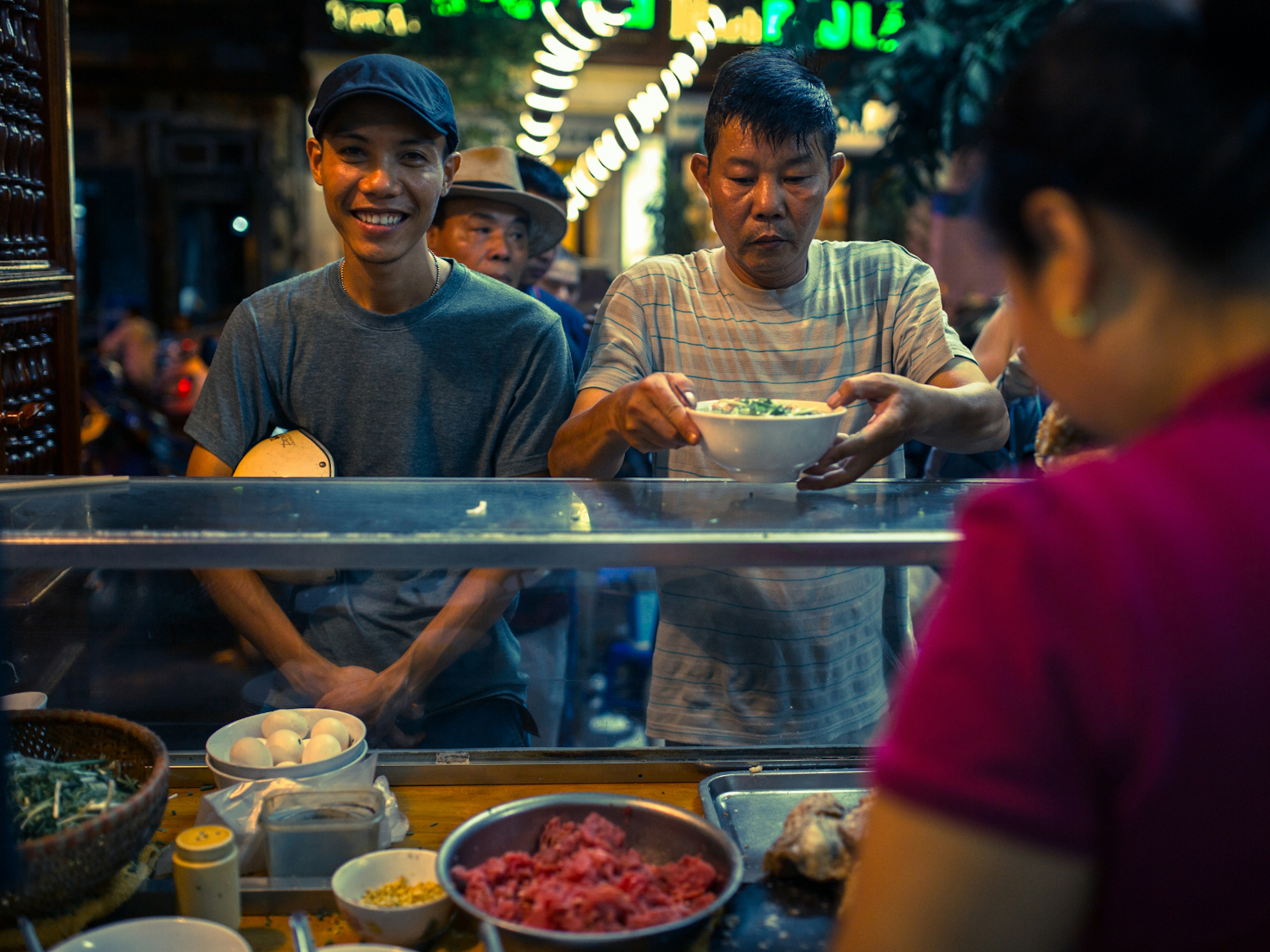 Locals queue up for a hearty bowl of pho in Hanoi