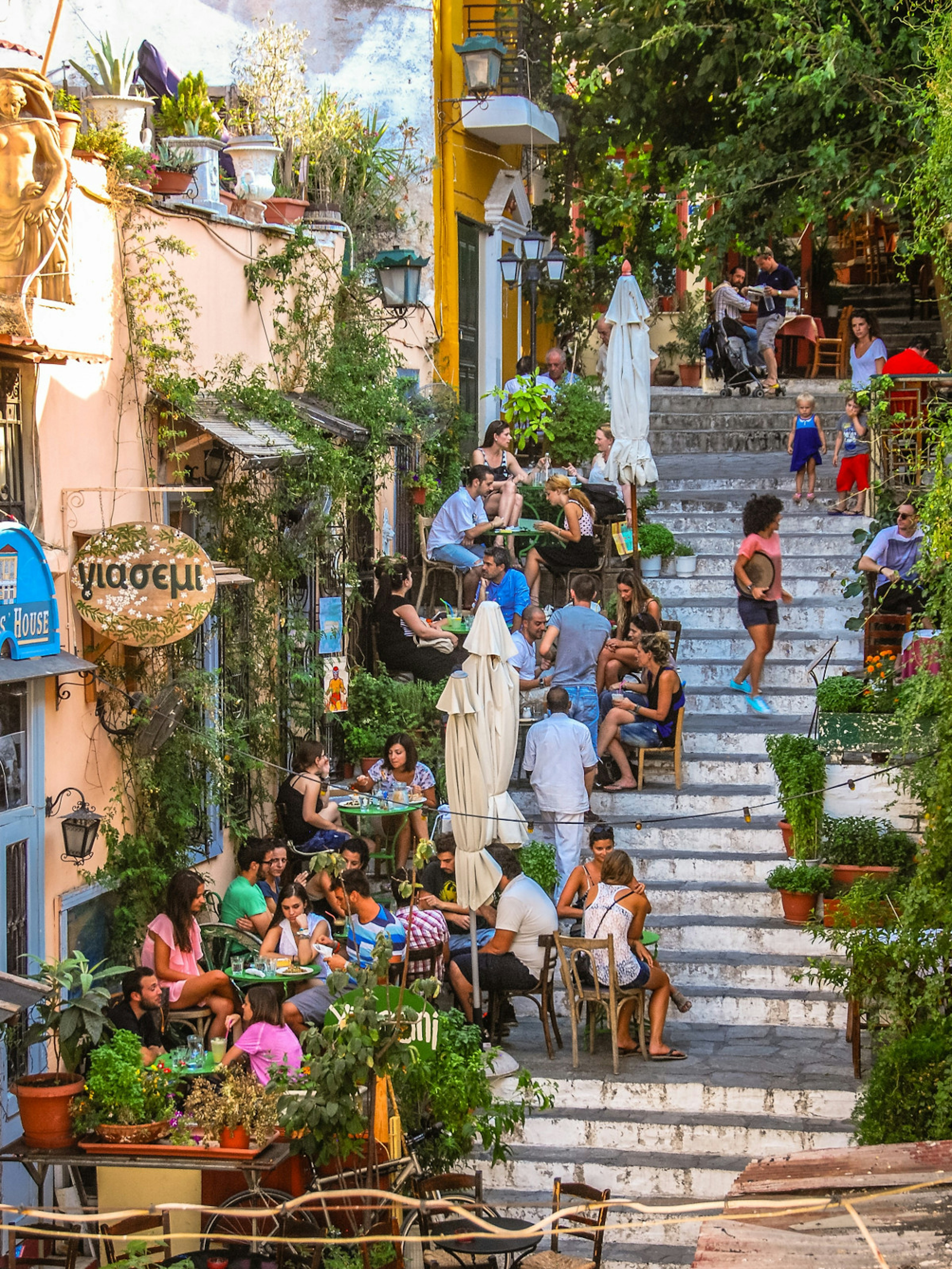 People dining outside on the stairs in the Plaka district of Athens