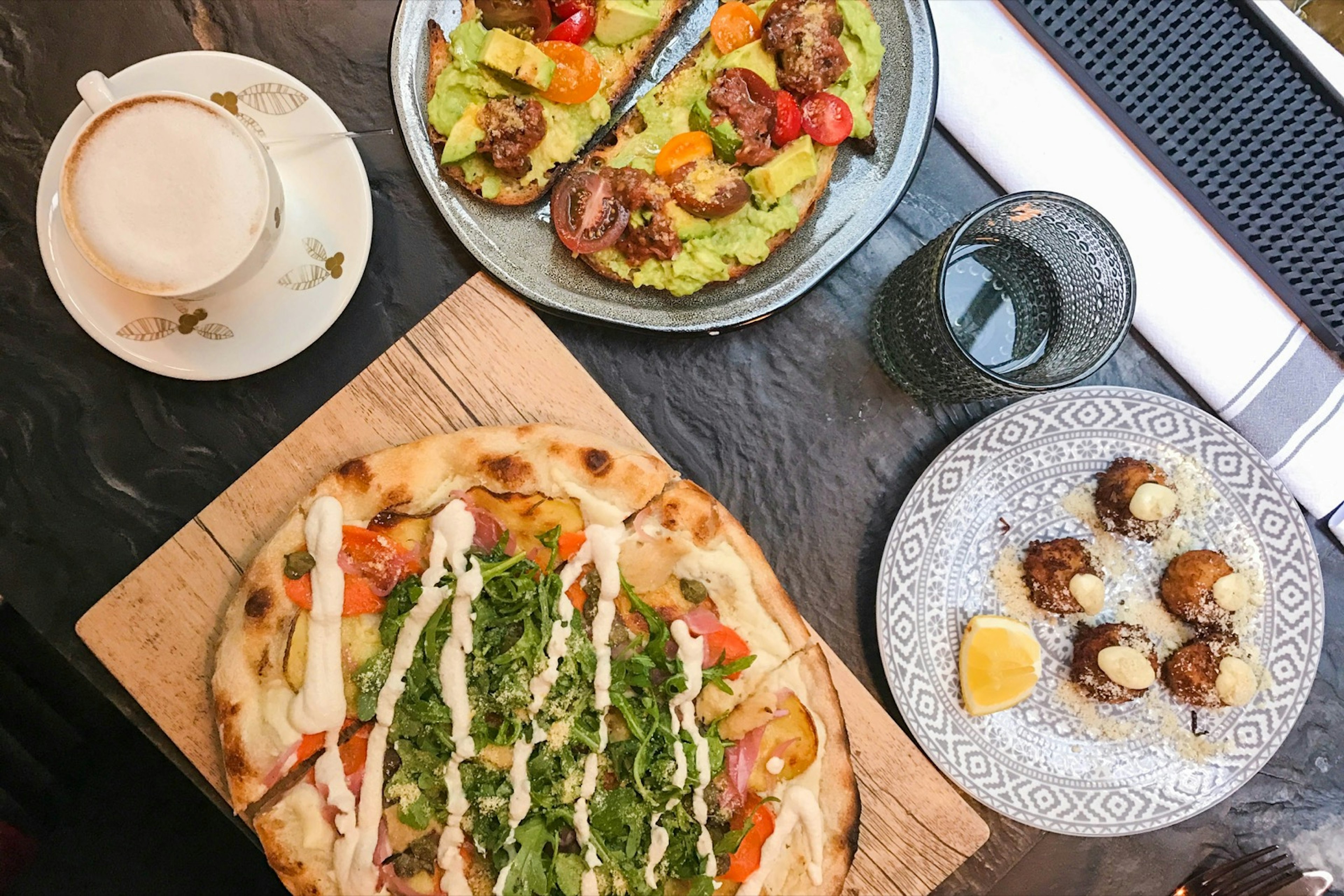 Looking down on a table covered in different brunch foods in Toronto