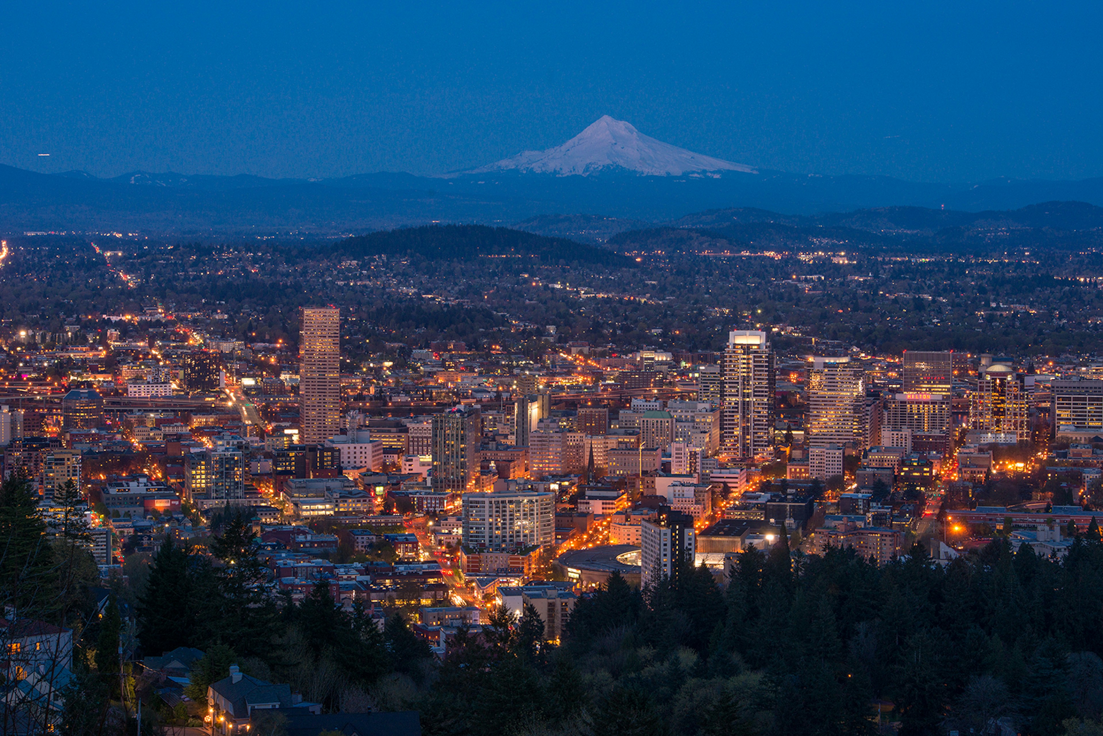 Downtown Portland at dusk from Pittock Mansion, with Mount Hood in the background © Piriya Photography / Getty Images