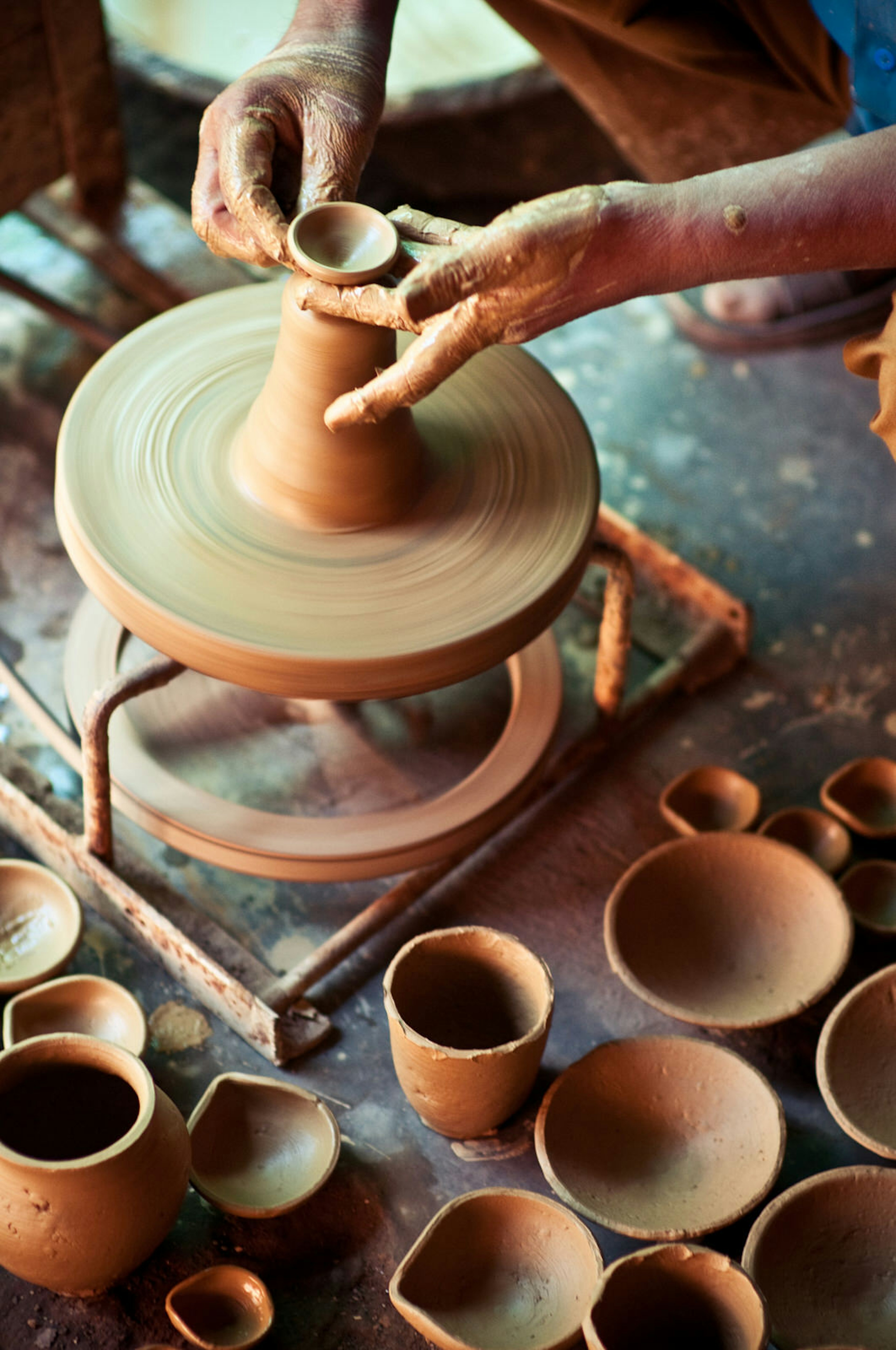 A potter making traditional butter lamps