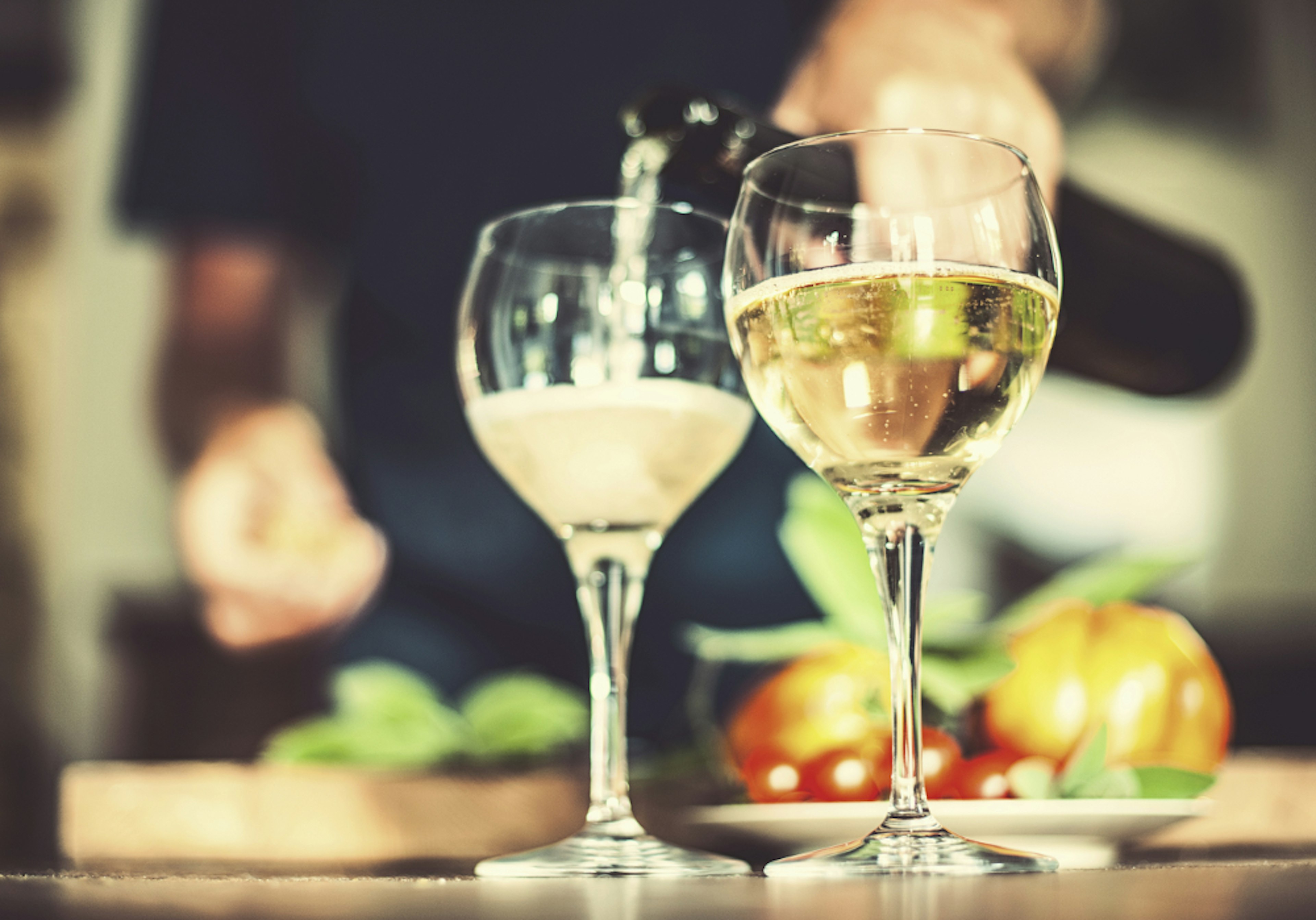 Sharing a bottle of Italian prosecco. Image by knape / Getty Images.