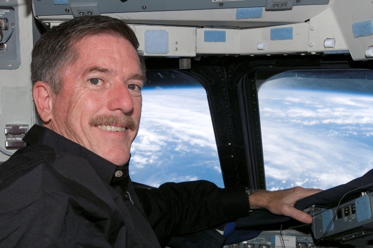Reilly enjoying the spectacular view from the Space Shuttle Atlantis.