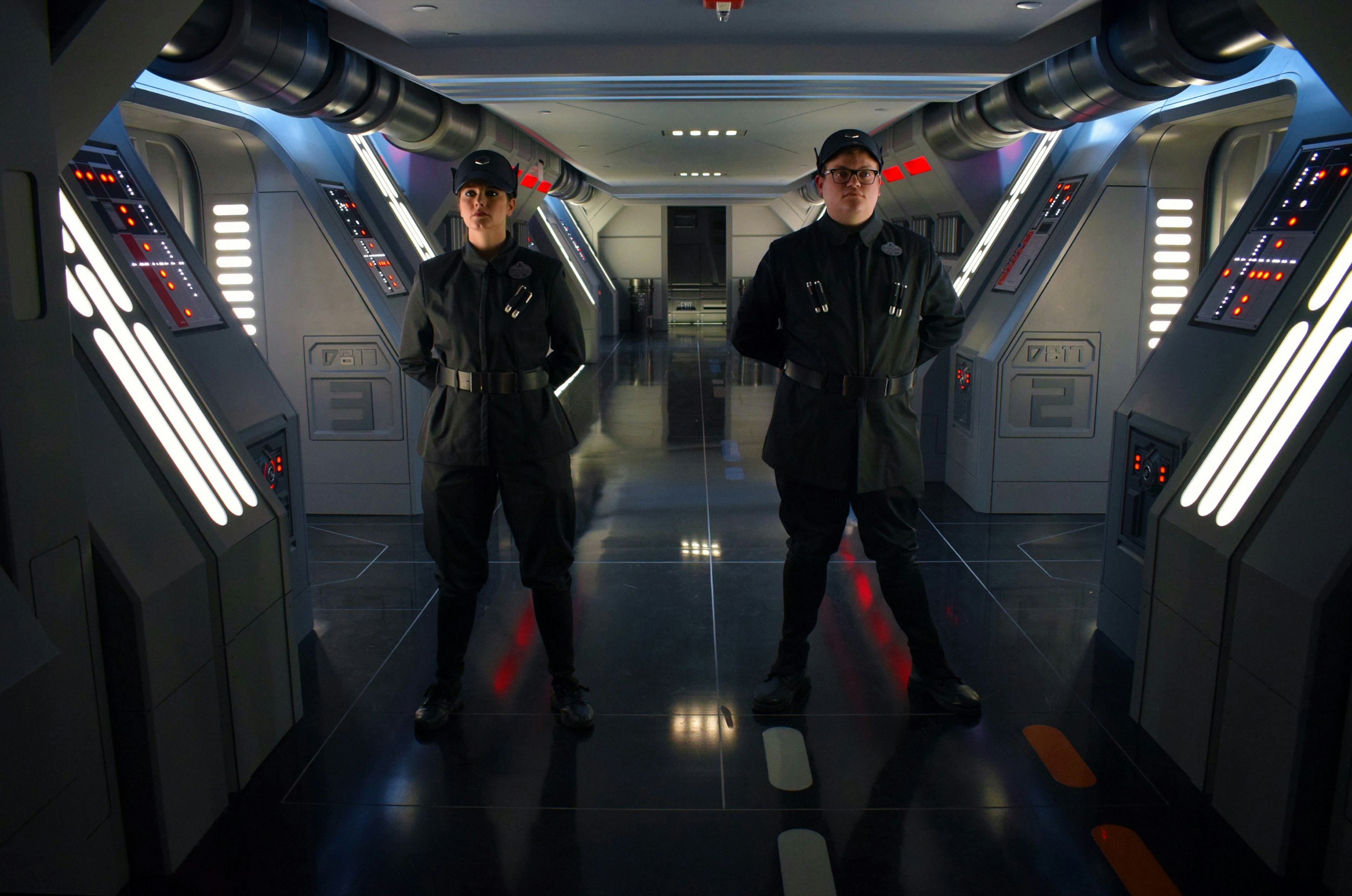 Two cast members stand at attention in the costumes of the Star Wars villains the First Order in a theme park ride in Florida