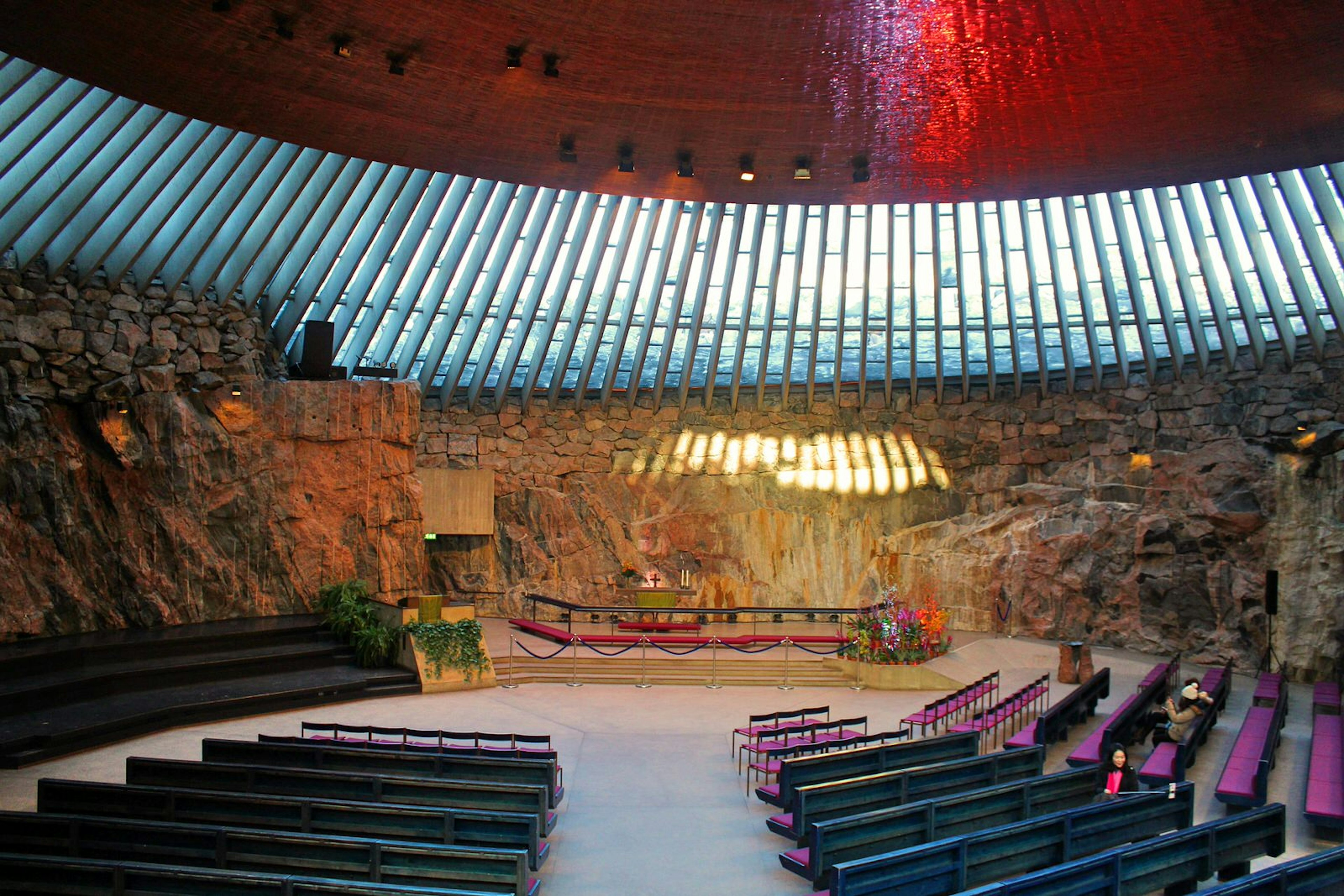 Visitors pausing for reflection inside Temppeliauko (the Rock Church), Helsinki