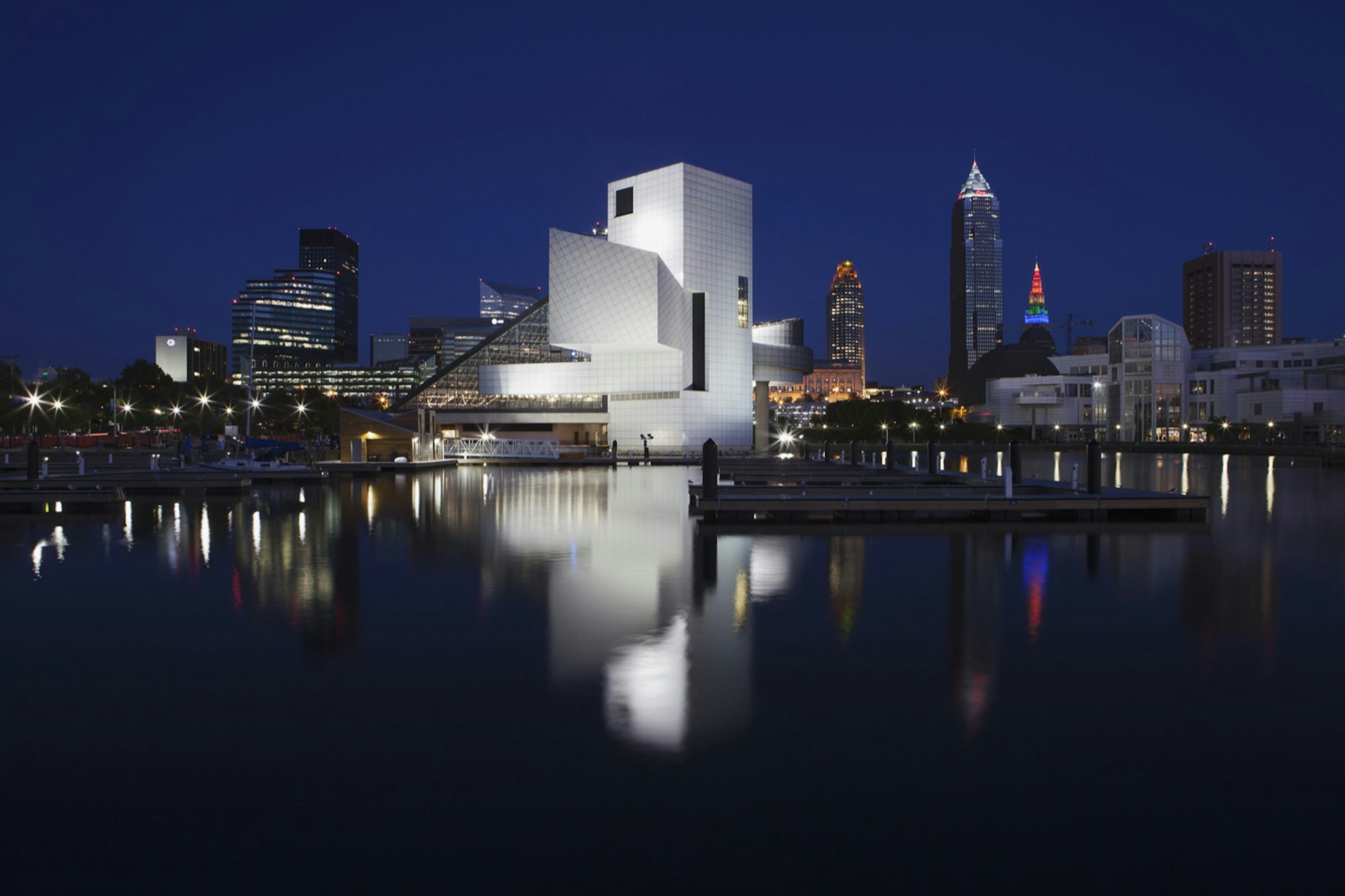 the white structure of rectangles, triangles and cylinders glows against a dark sky