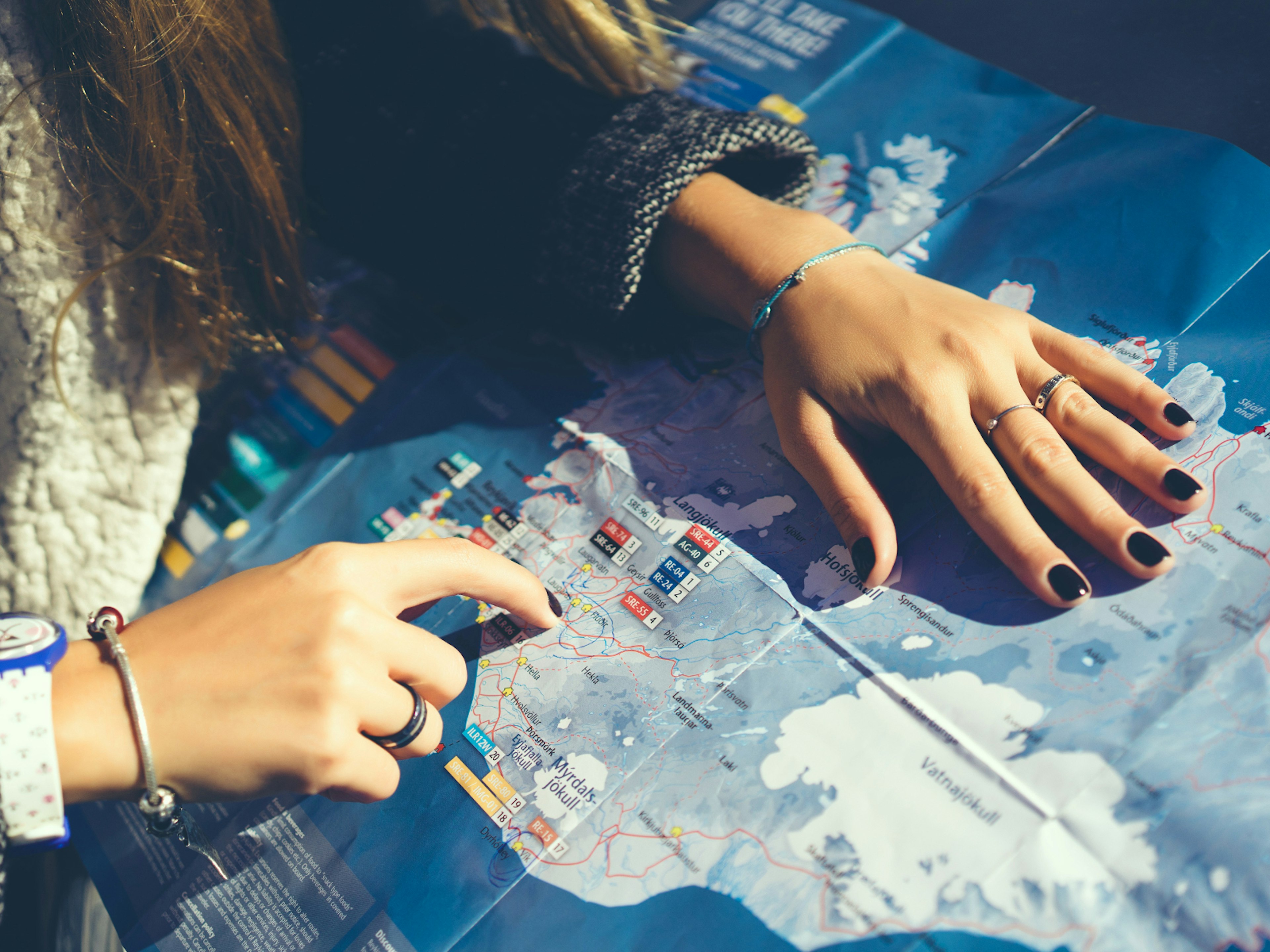 A woman plotting a route on a map