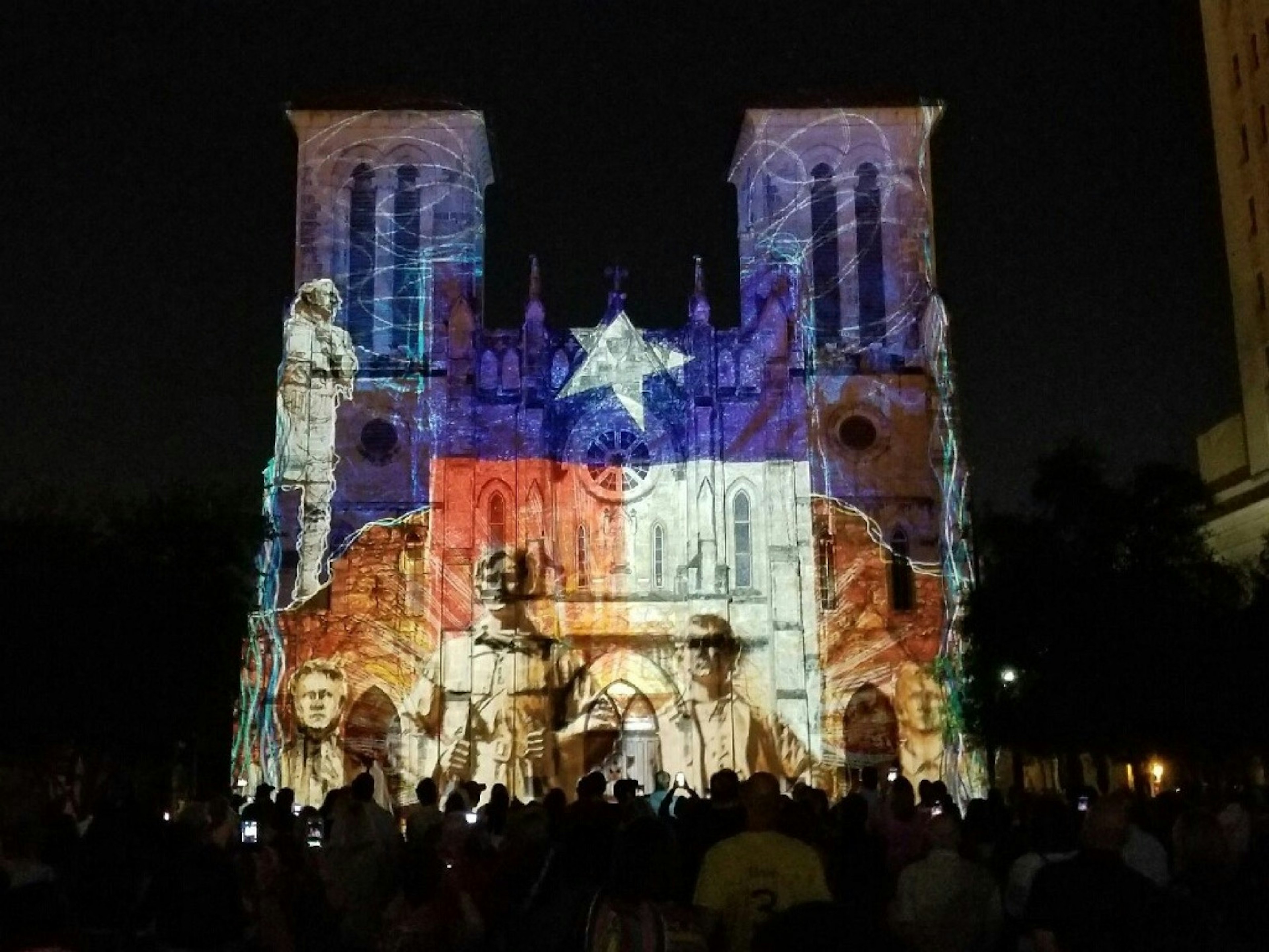 Scenes of San Antonio history, with the colors and star of the Texas flag, are projected on the front of a cathedral © Vicki Arkoff / Lonely Planet